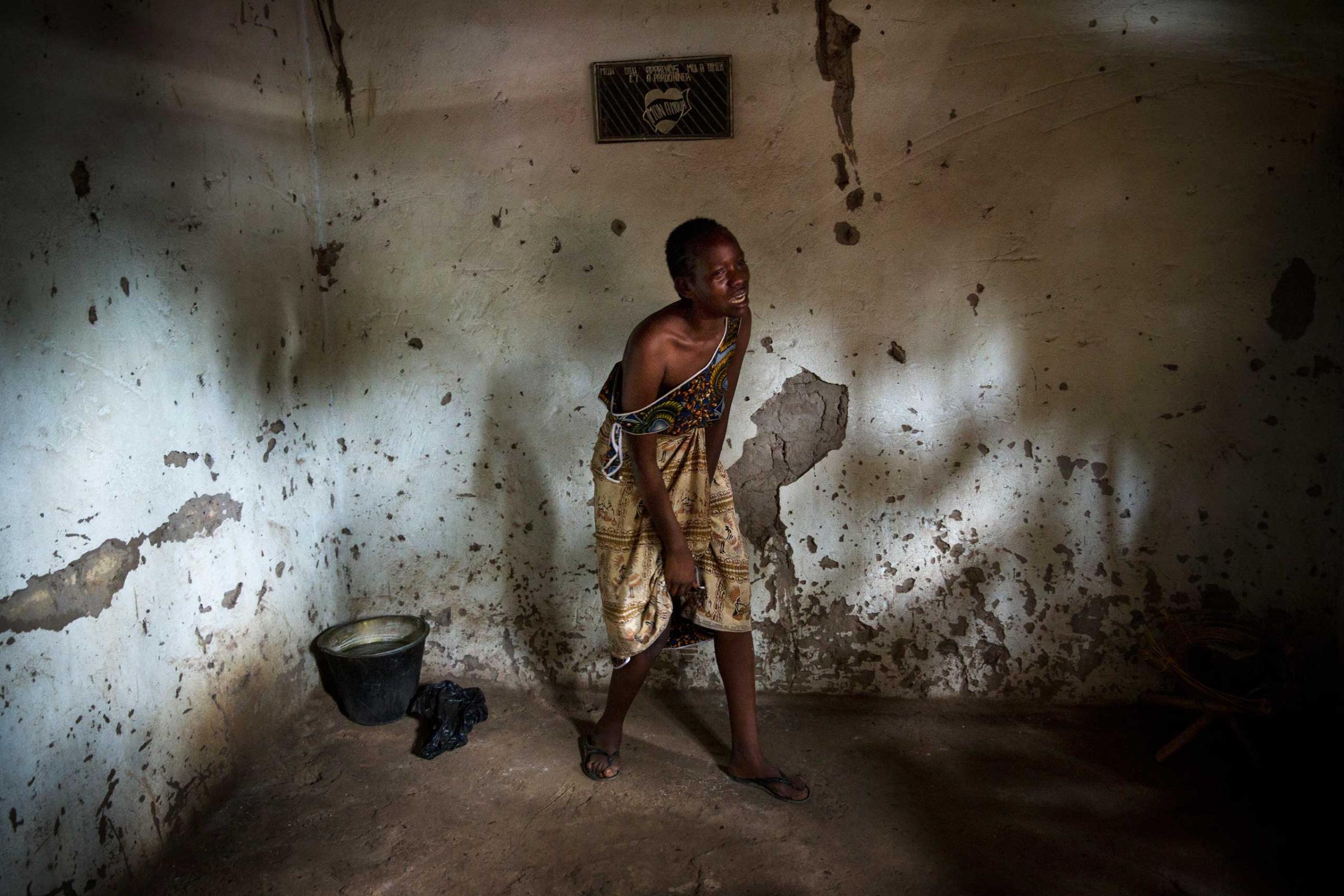 Dec. 9, 2013: A female relative grieves over the death of Sept-Abel Sangomalet, 20, who was allegedly stabbed by Muslims while sleeping at his family home in Bangui.