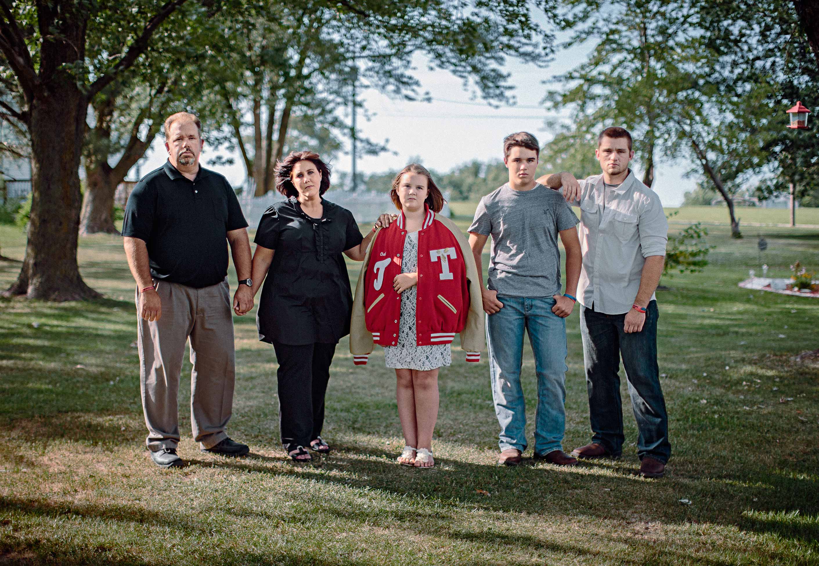 From left: Chad’s father Ken, mother Amy and siblings Mandy, Kenton and Zane in the family’s yard in central Missouri. Kenton, a high school freshman, has given up football. Photographed in Tipton, Mo, in 2014. (Bryan Schutmaat for TIME)