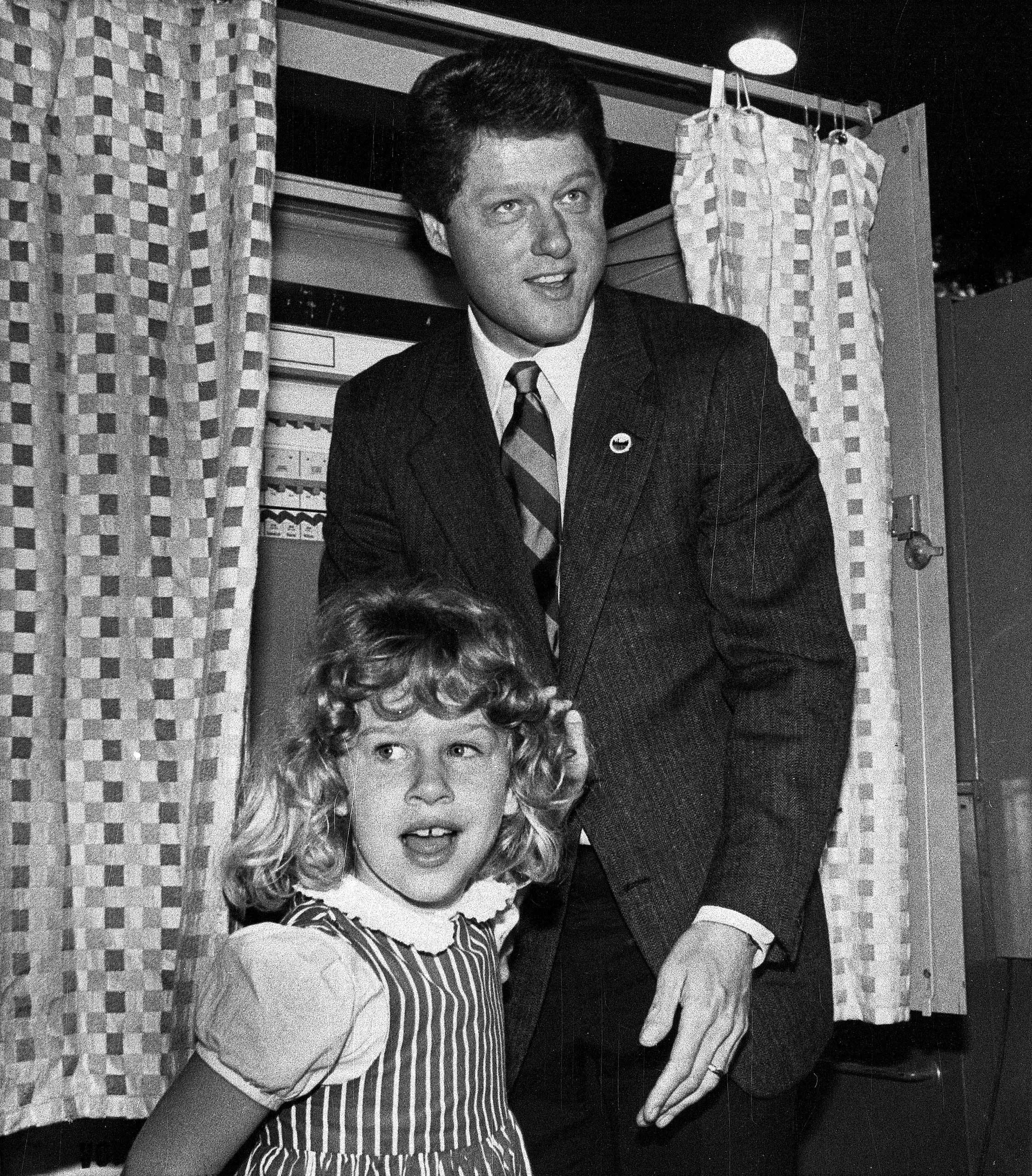 Arkansas Gov. Bill Clinton and daughter, Chelsea, 6, leave the voting booth after the governor cast his vote during the Democratic primary in Little Rock, Ark., on May 27, 1986.