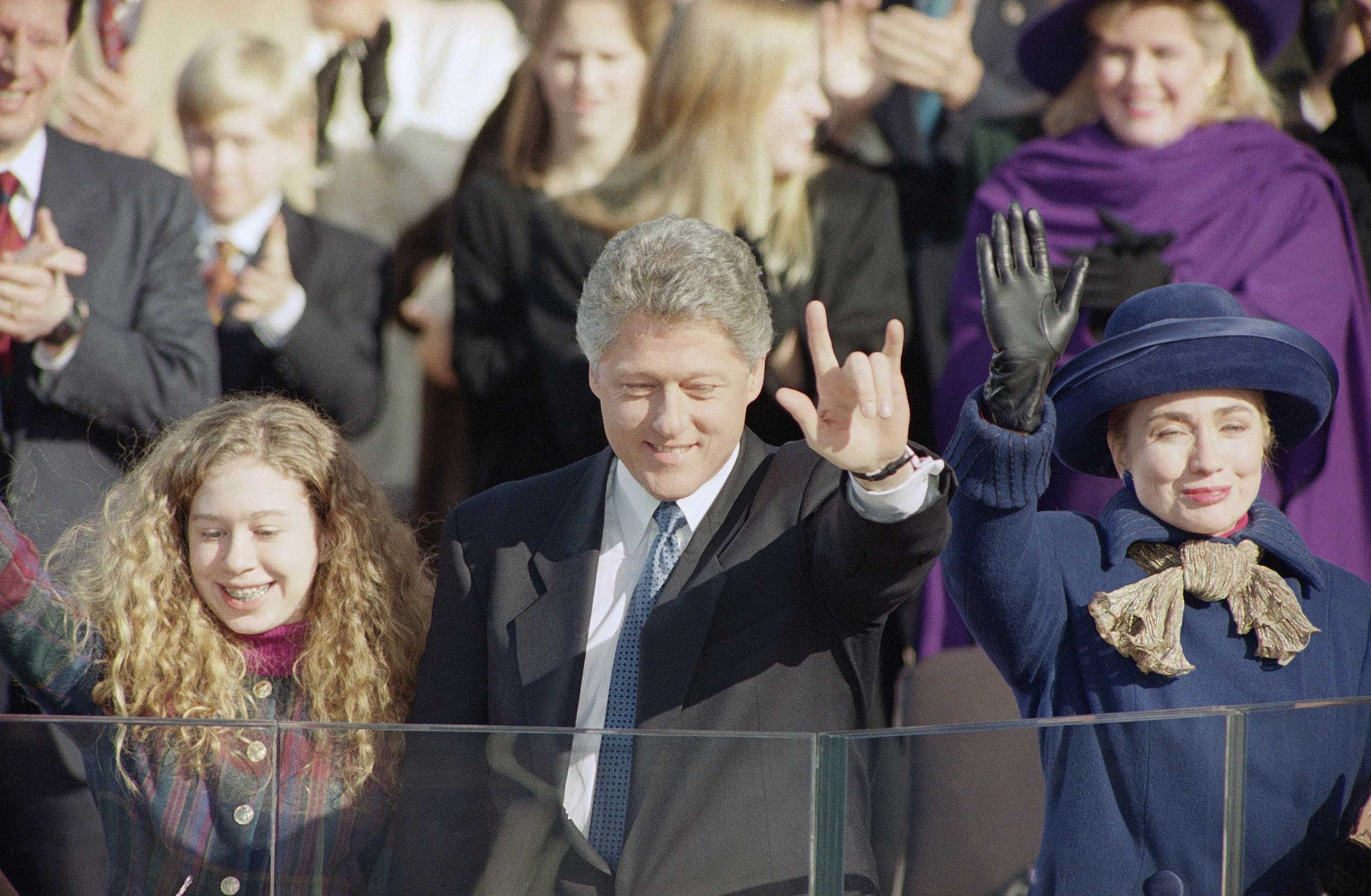 President Bill Clinton with daughter Chelsea, left and first lady Hillary Rodham Clinton wave to the crowd after taking the oath of office in Washington, Jan. 20, 1993.