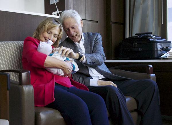 Hillary and Bill Clinton with their granddaugther Charlotte