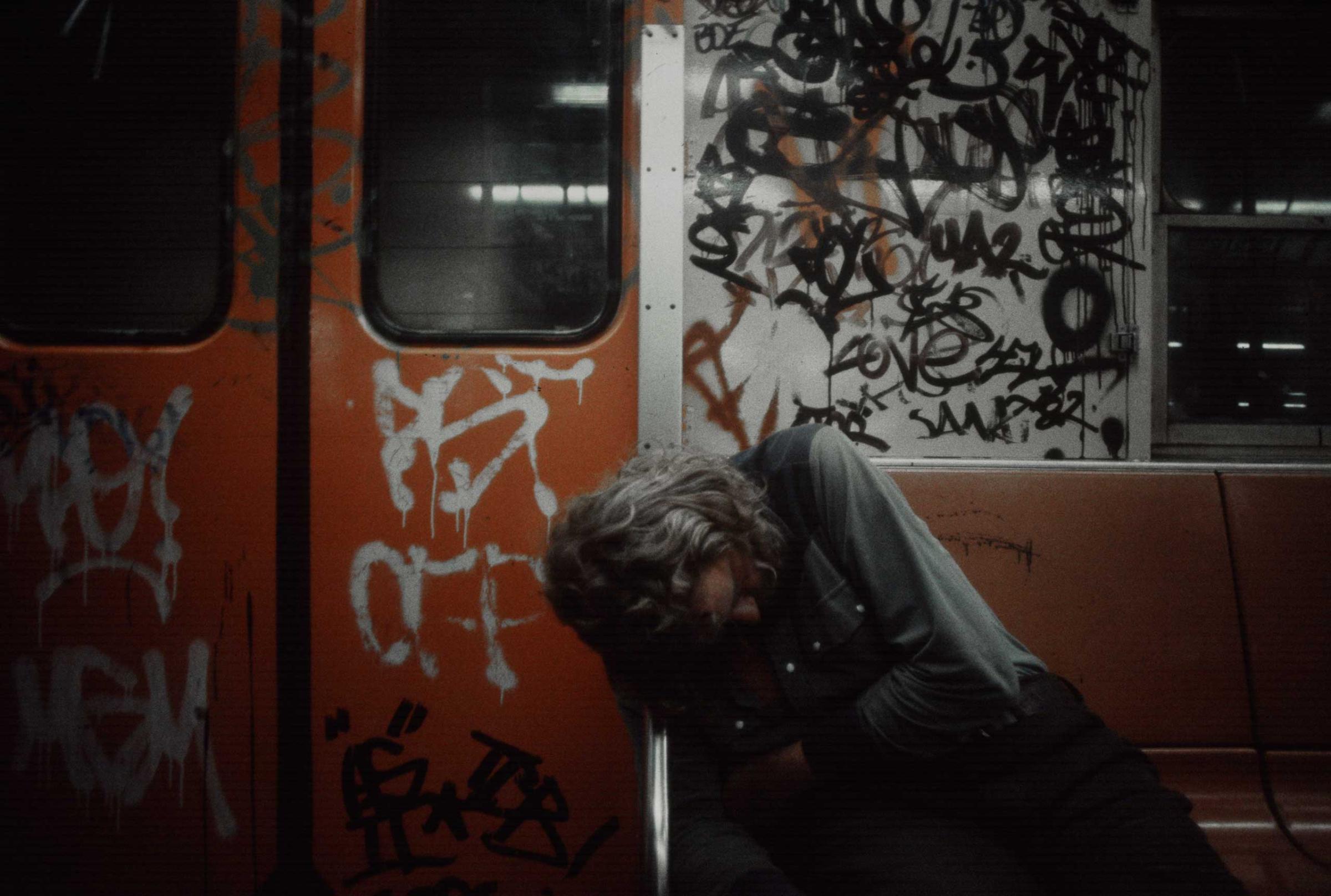 A man sleeps in a subway car, 1981.