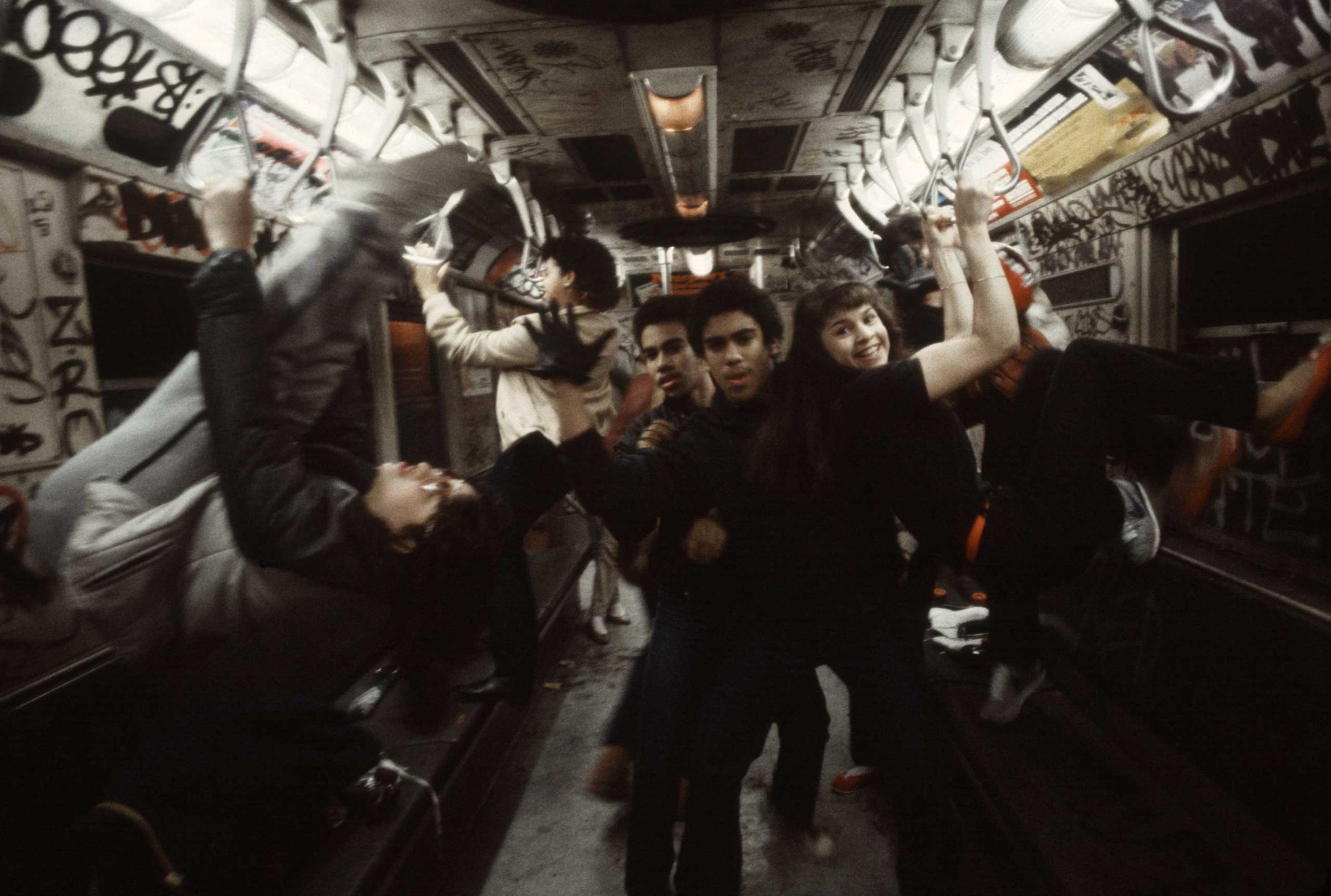 A group of teens pose on the 6 train in the South Bronx, 1981.