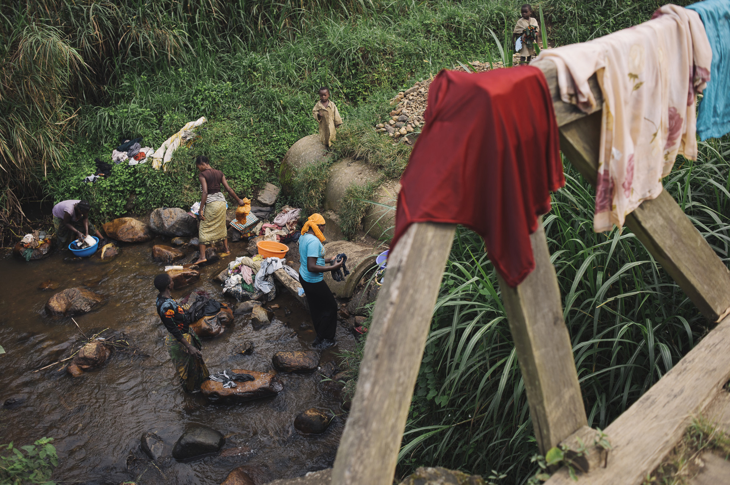 Ladies wash clothes in the river flowing through the town of Nyabiondo in eastern Congo, July 23, 2014.