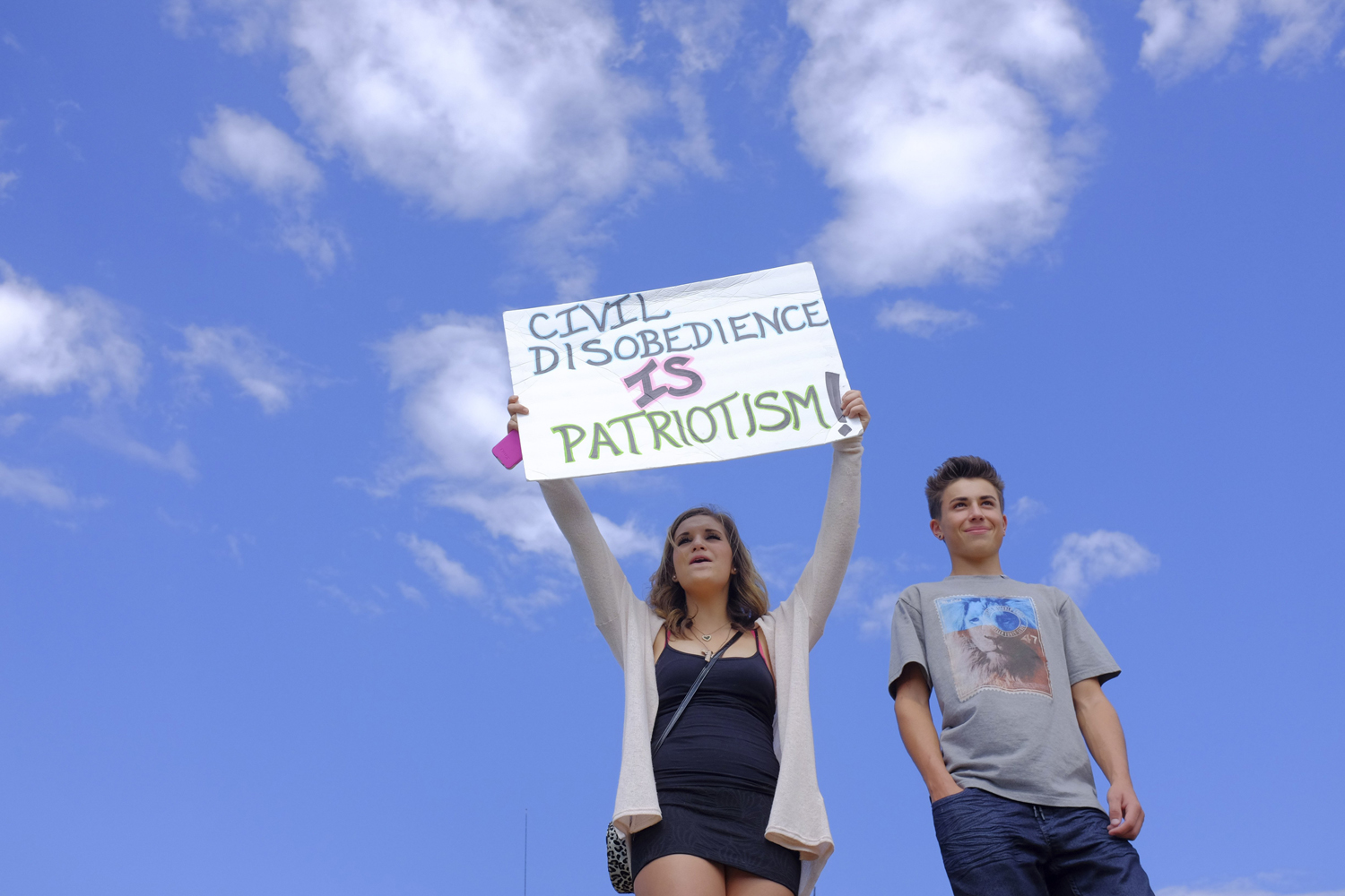 Ella Gonzales and Jordan Miller, high school students, take part in a walkout protest outside Arvada West High School in Arvada, Colo., Sept. 23, 2014.