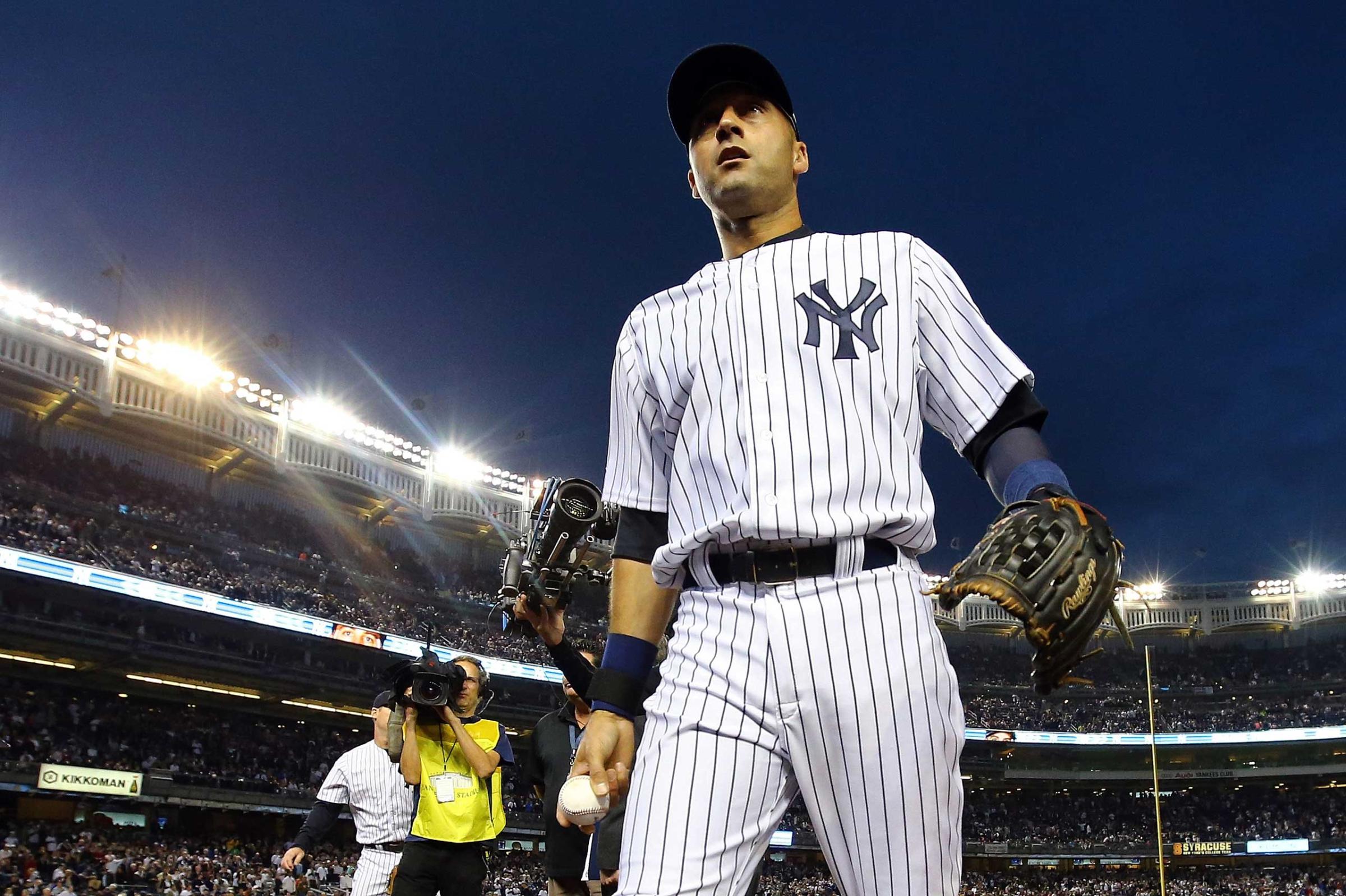 Derek Jeter of the New York Yankees walks into the dugout against the Baltimore Orioles at Yankee Stadium on Sept. 25, 2014.