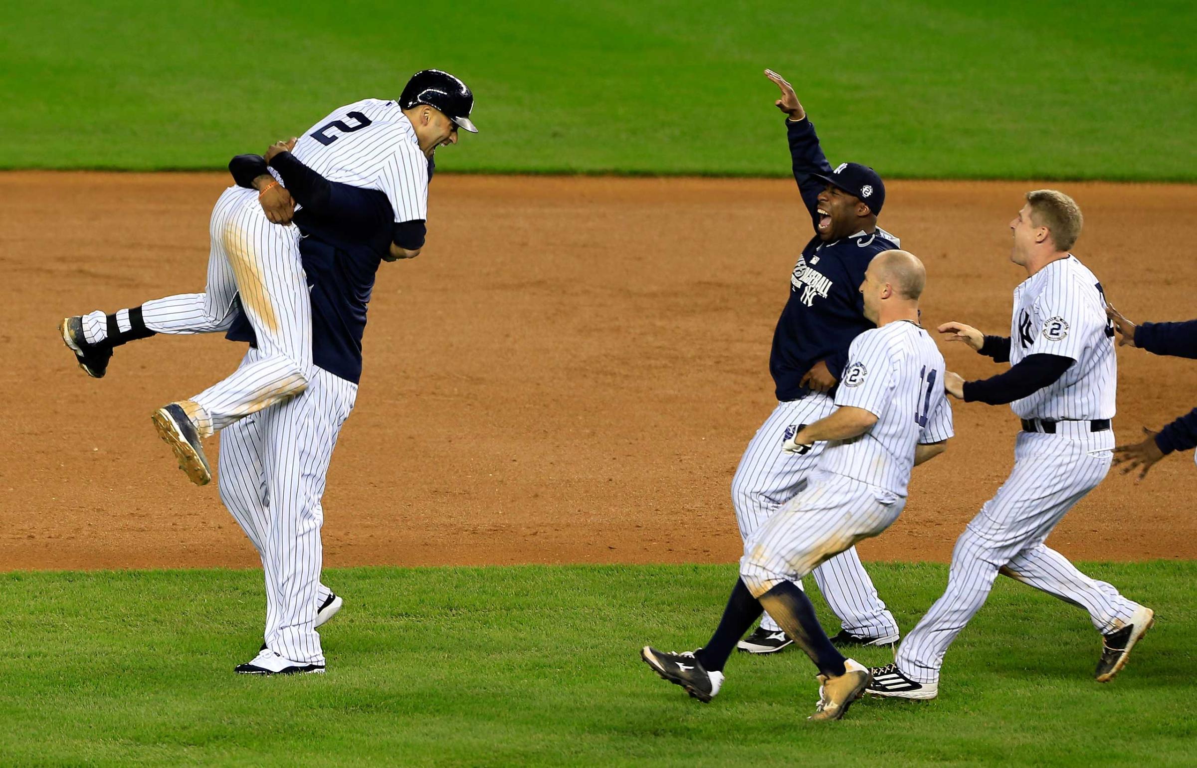 Derek Jeter celebrates with his teammates after a game winning RBI hit in the ninth inning against the Baltimore Orioles in his last game ever at Yankee Stadium on Sept. 25, 2014.