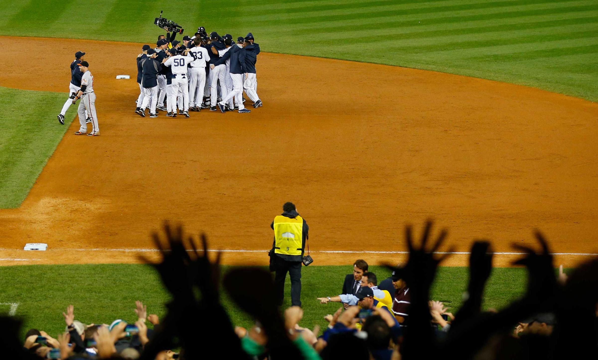 Derek Jeter celebrates with his team after a game winning RBI hit in the ninth inning against the Baltimore Orioles in his last game ever at Yankee Stadium on Sept. 25, 2014.