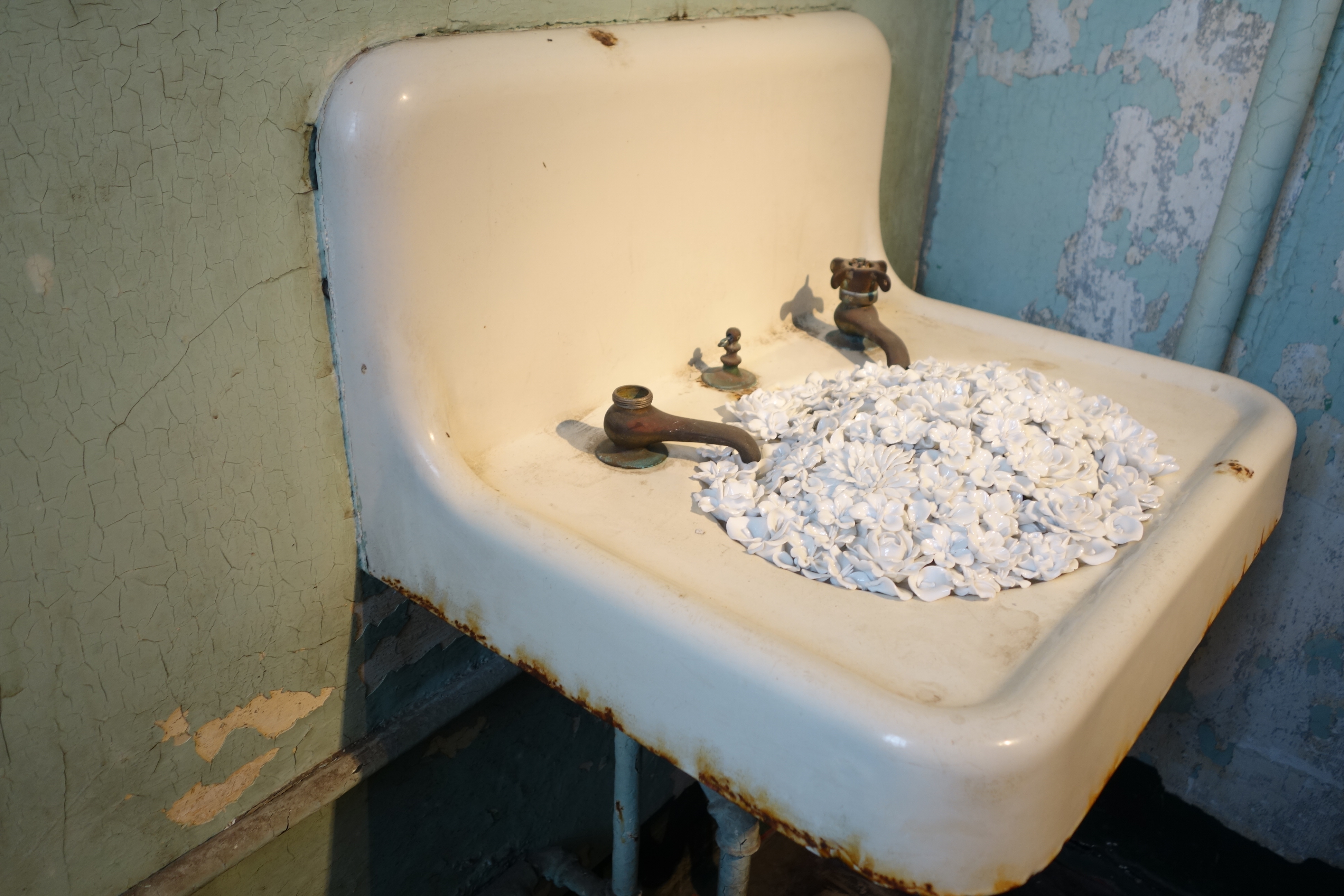 In "Blossom," Weiwei fills hospital wing amenities like sinks and bathtubs with intricate porcelain flower sculptures, pictured on Sept. 24, 2014. (Katy Steinmetz for TIME)