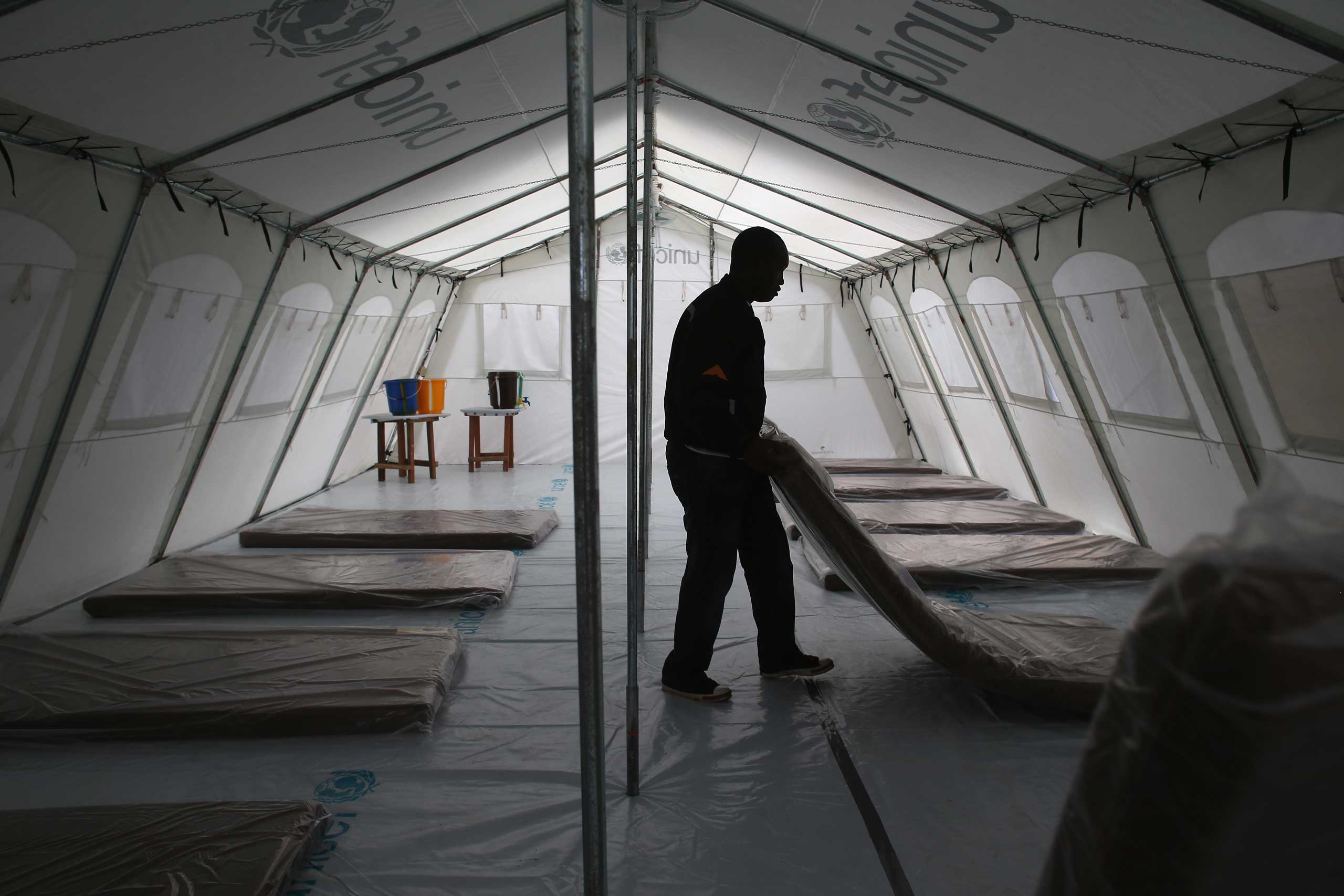 Workers prepare the new Doctors Without Borders Ebola treatment center on Aug. 17, 2014 near Monrovia.