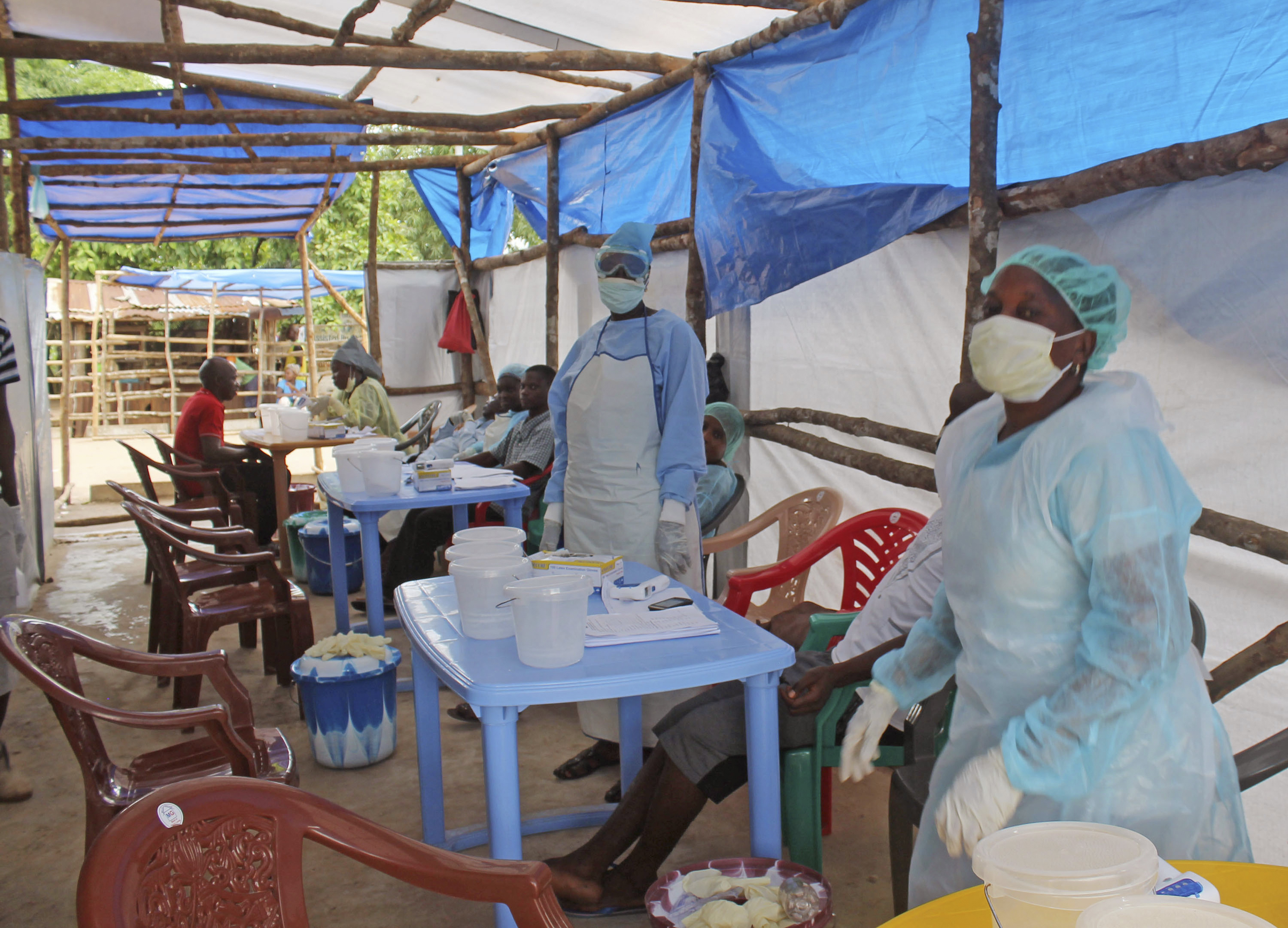 Medical personnel inside a clinic take care of Ebola patients in the outskirts of Kenema, Sierra Leone, on  July 27, 2014 (Youssouf Bah—AP)