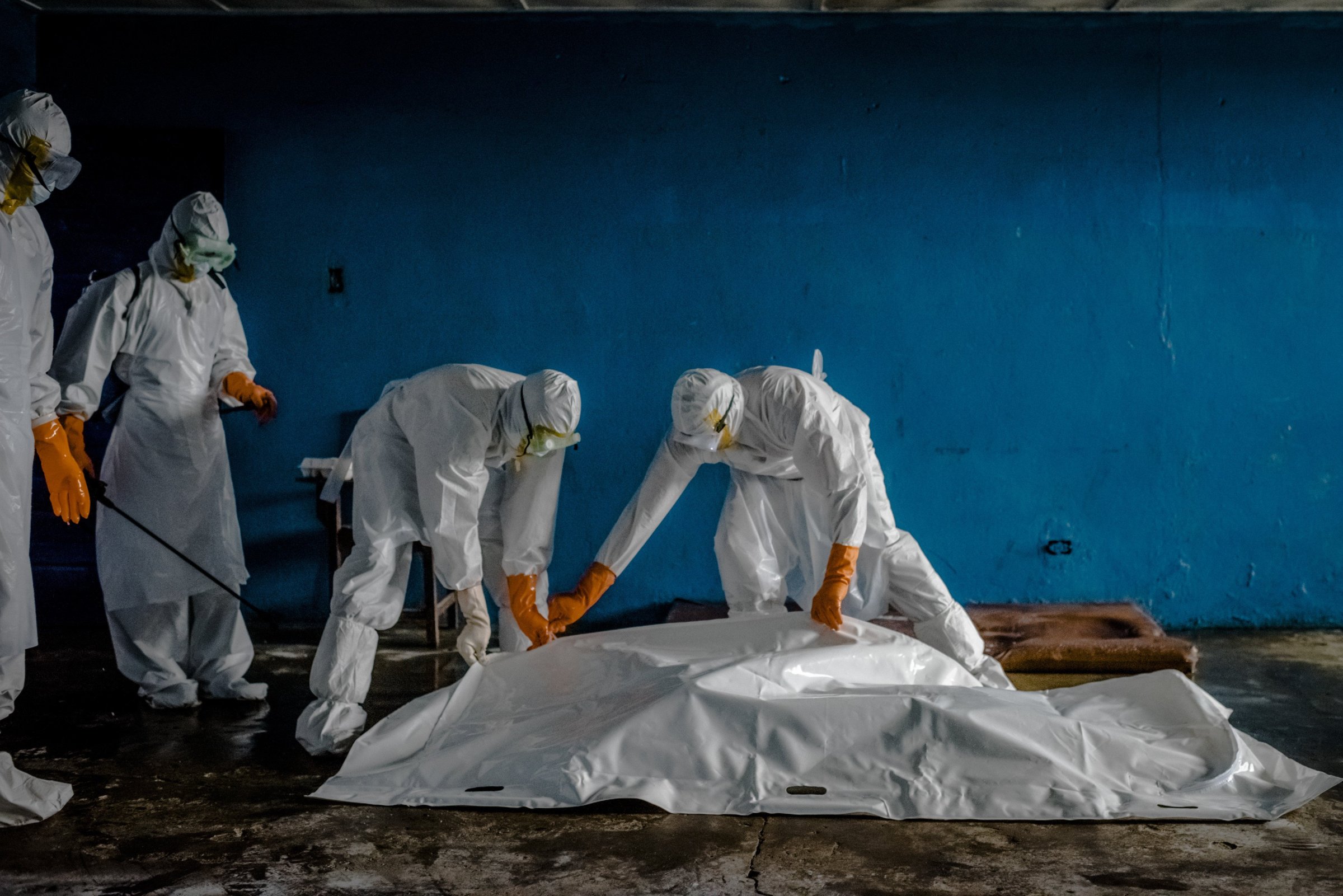 A burial team in protective clothing retrieves the body of an Ebola victim from an isolation ward in the West Point neighborhood of Monrovia, the capital of Liberia on Aug. 28, 2014.