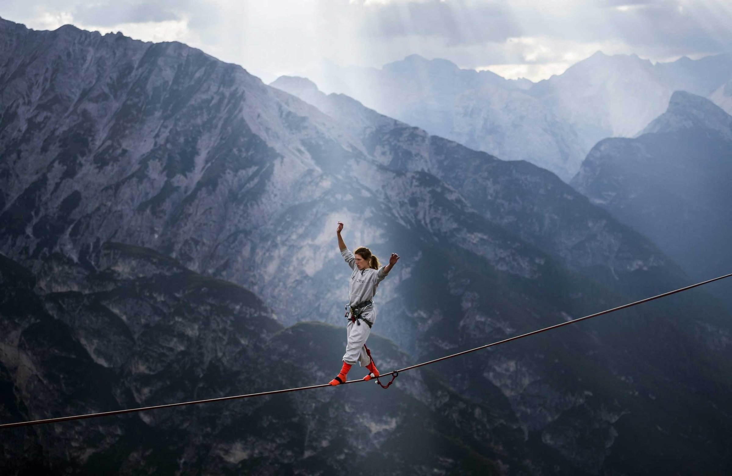 An extreme athlete balancing on a webbing during the International Highline Meeting in Monte Piana, near Misurina, in the northern Italian Alps, Italy on Sept. 11, 2014.