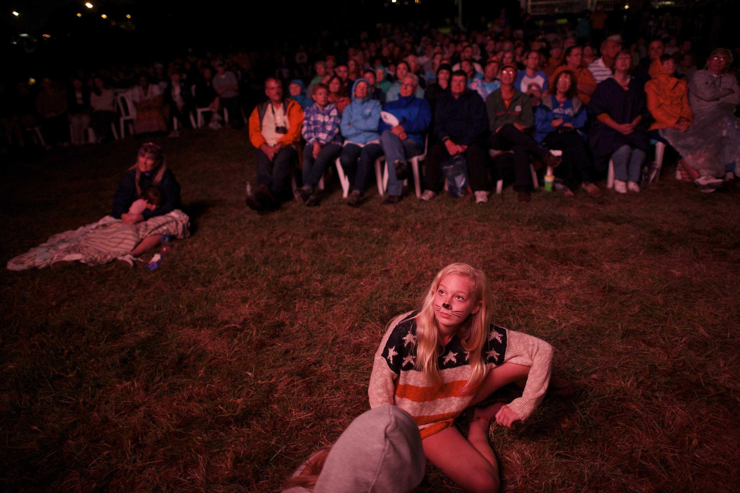 A girl watches a monitor during a during a fireworks display commemorating the bicentennial of the writing of The Star-Spangled Banner at Fort McHenry National Historic Park on Sept. 13, 2014 in Baltimore.