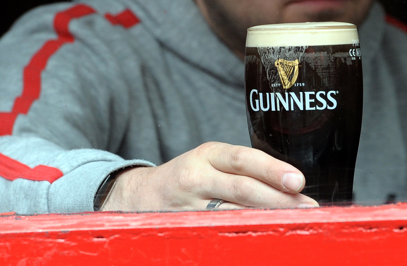 A man is pictured through the window of a bar drinking a pint of Guinness in The Temple Bar area of Dublin, Ireland on May 20, 2011. (Paul Ellis—AFP/Getty Images)
