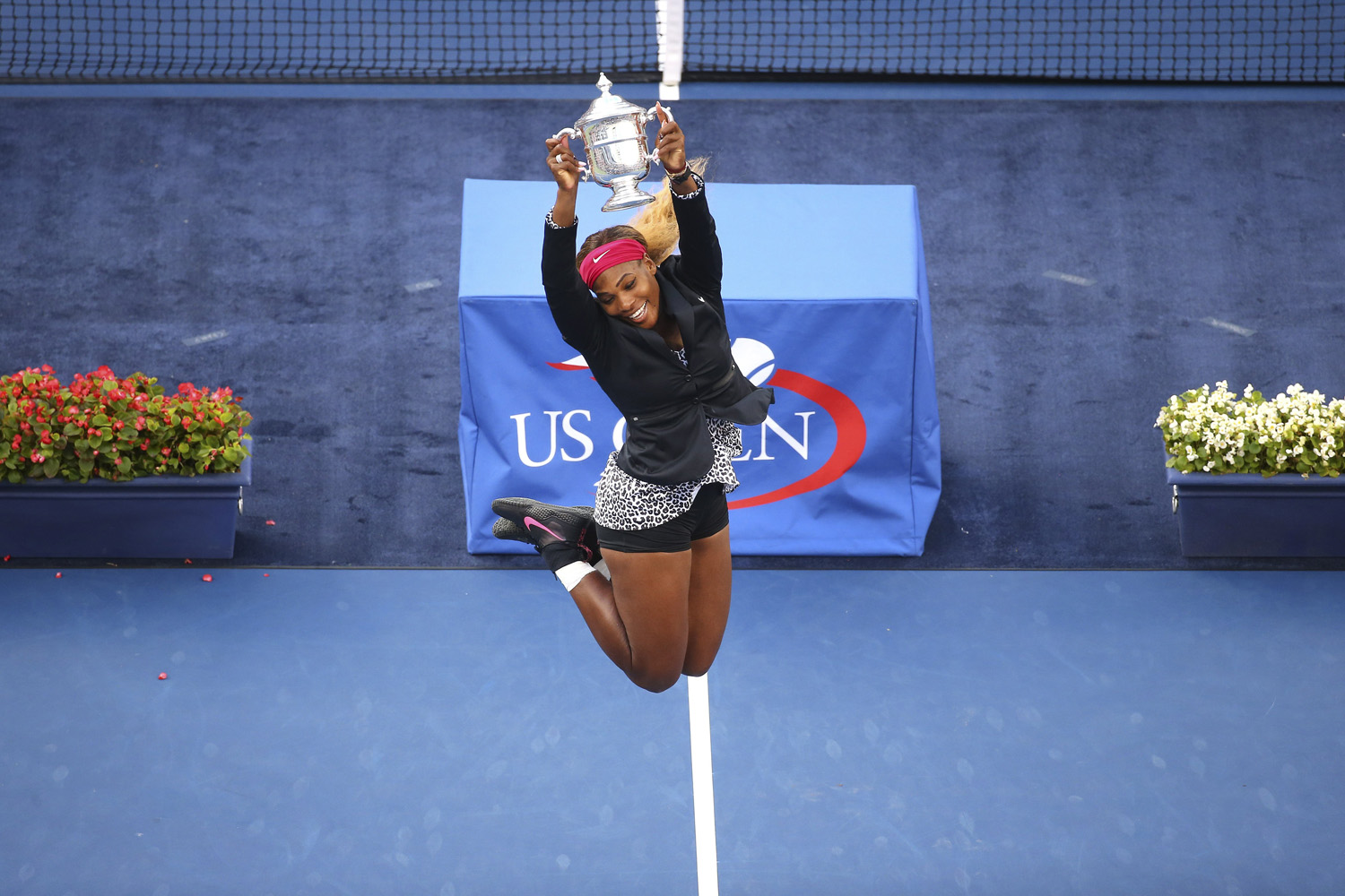 Serena Williams of the U.S. leaps with the trophy after defeating Caroline Wozniacki of Denmark in the womenís singles final at the U.S. Open tennis tournament in Arthur Ashe Stadium in New York on Sept. 7, 2014.