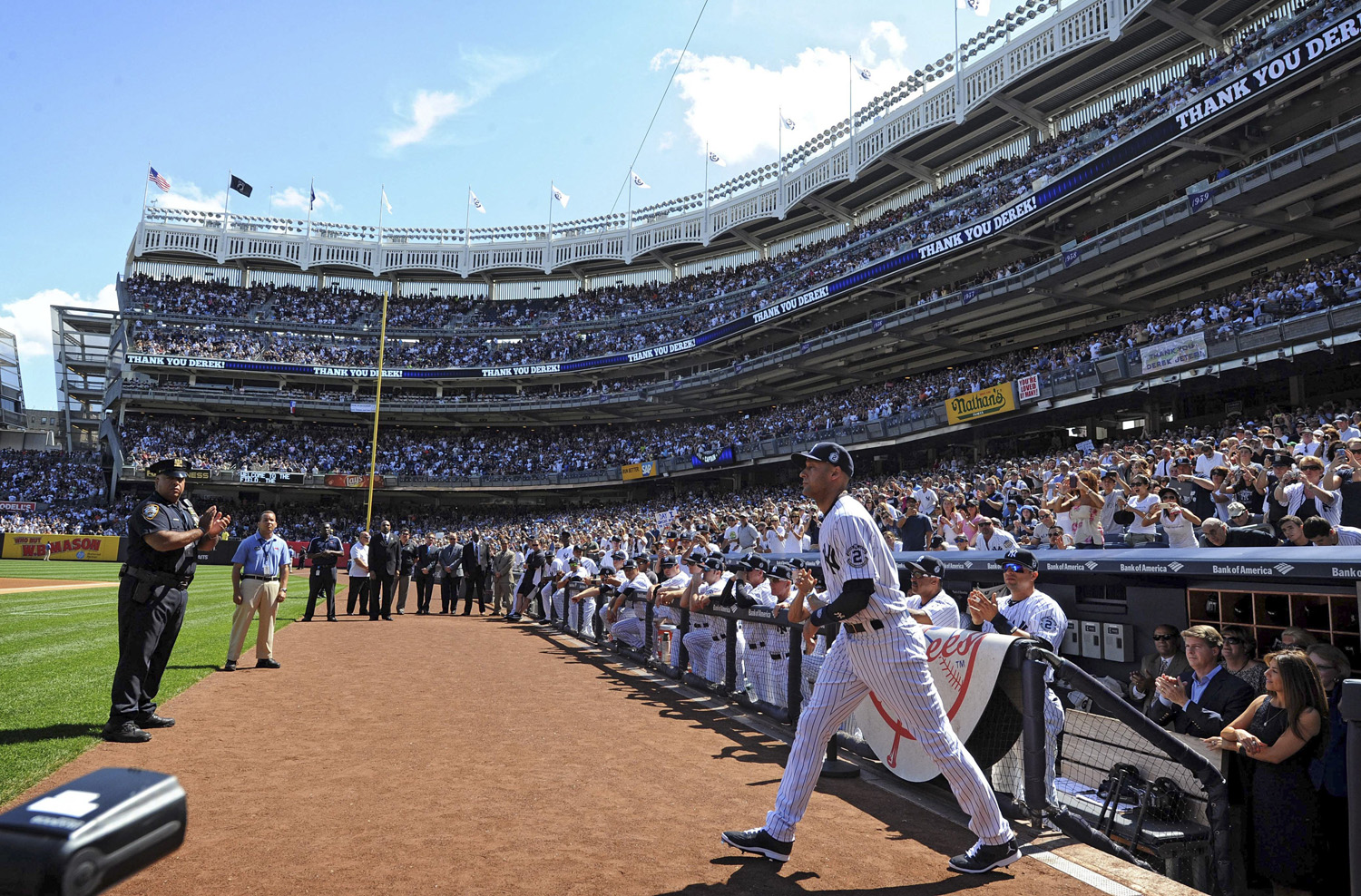 Yankees shortstop Derek Jeter strides onto the field as he is introduced for Derek Jeter Day events.