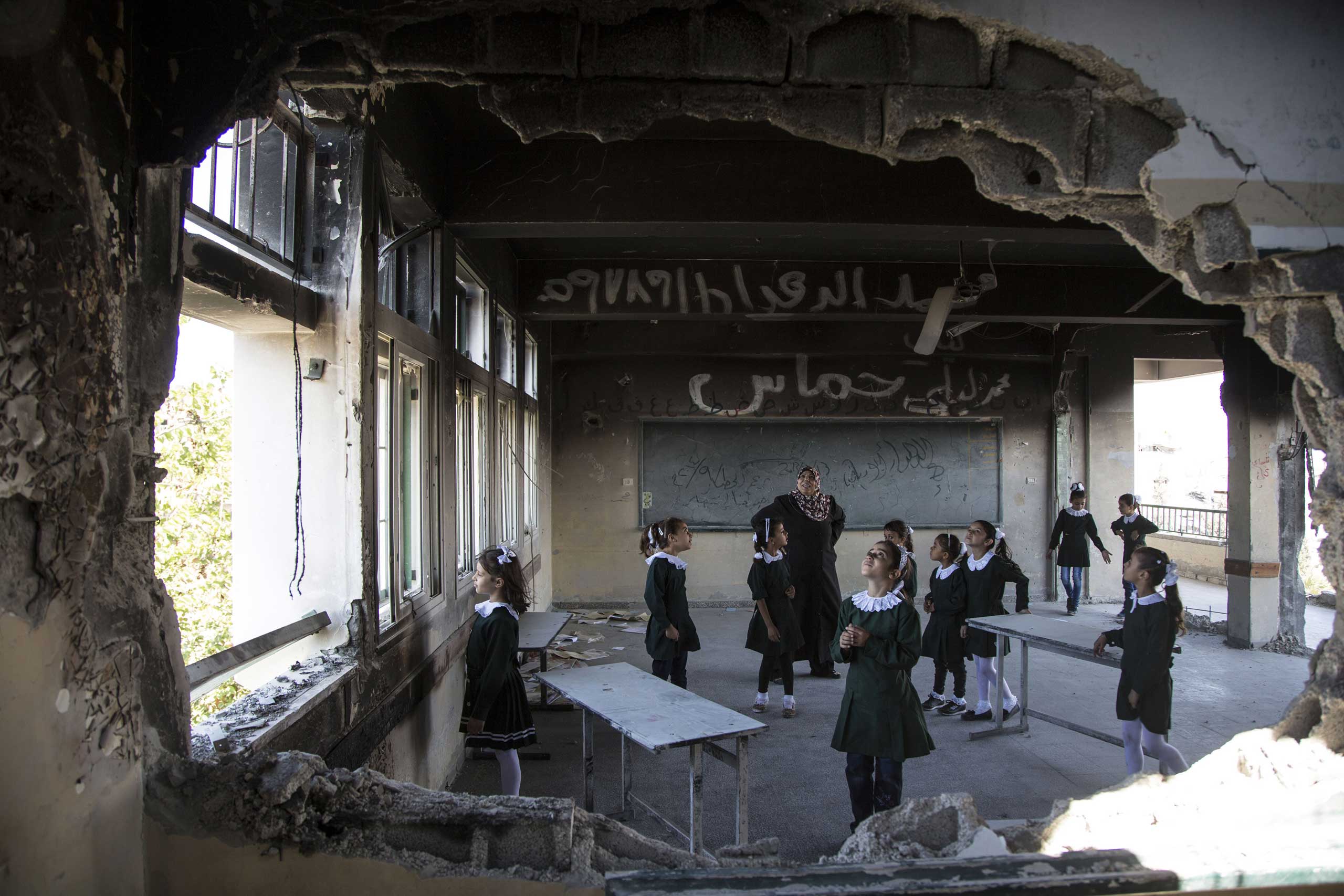 Sept. 14, 2014. Palestinian students inspect their destroyed classroom on the first day of classes in the Shejaiya neighborhood of Gaza City.