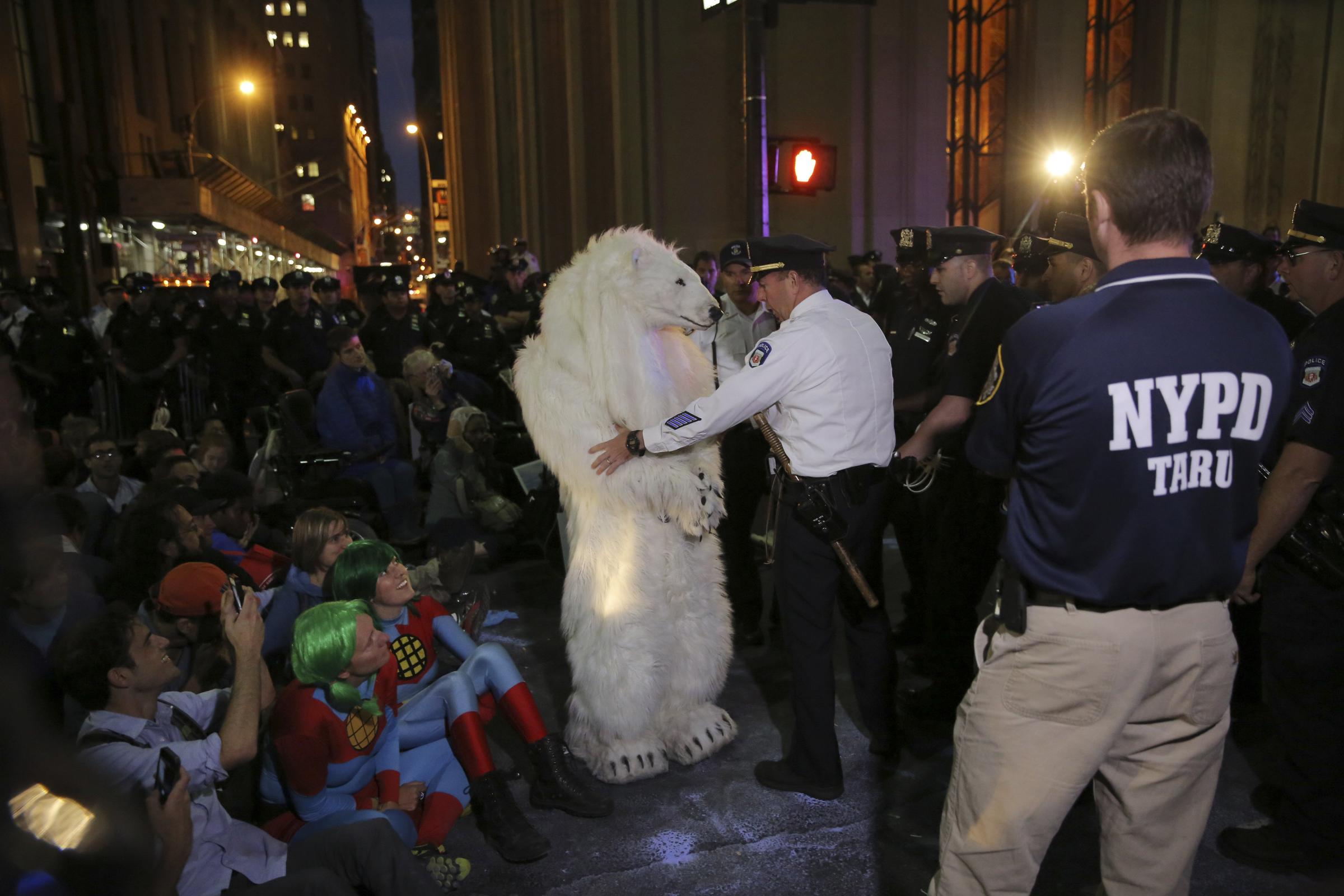 Police arrest a demonstrator dressed in a polar bear costume during the "Flood Wall Street" protest to bring awareness to climate change, in New York on Sept. 22, 2014.
