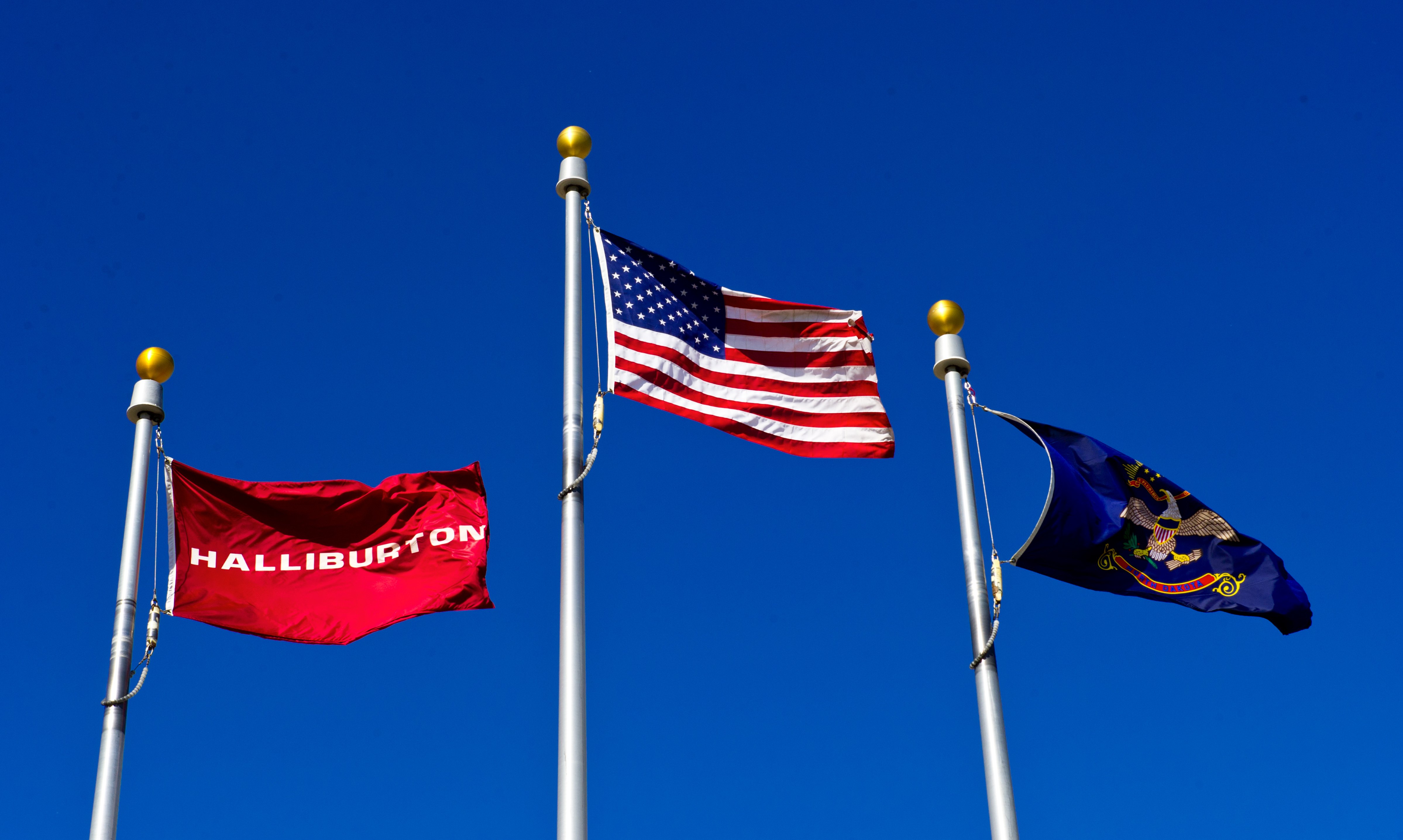 Flags flying at a Halliburton facility in Williston, North Dakota on Aug. 20, 2013.