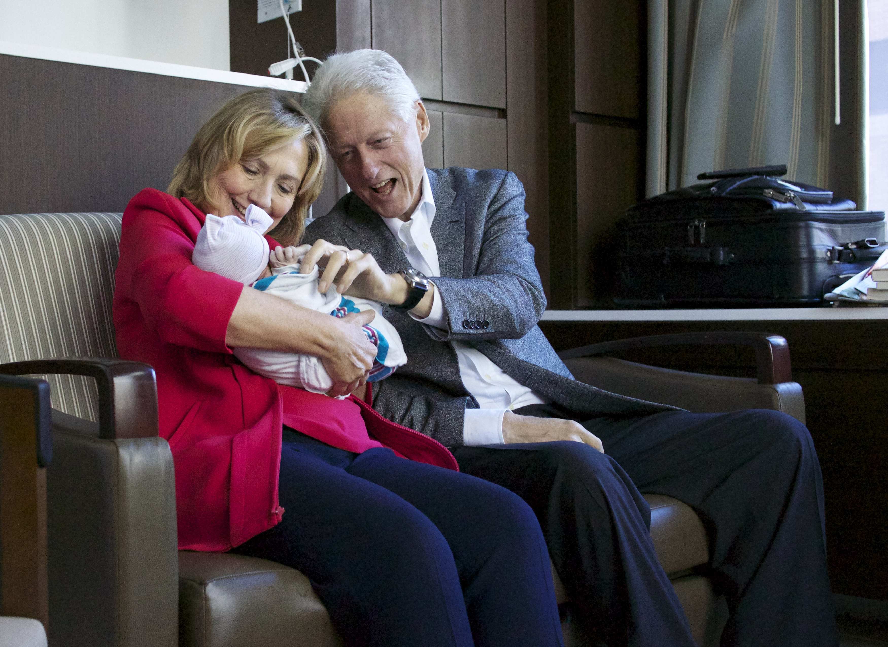 Former President Bill Clinton and his wife, former Secretary of State Hillary Clinton, hold their granddaughter Charlotte Clinton Mezvinsky after their daughter Chelsea Clinton gave birth in New York on Sept. 27, 2014. (Jon Davidson—Reuters)