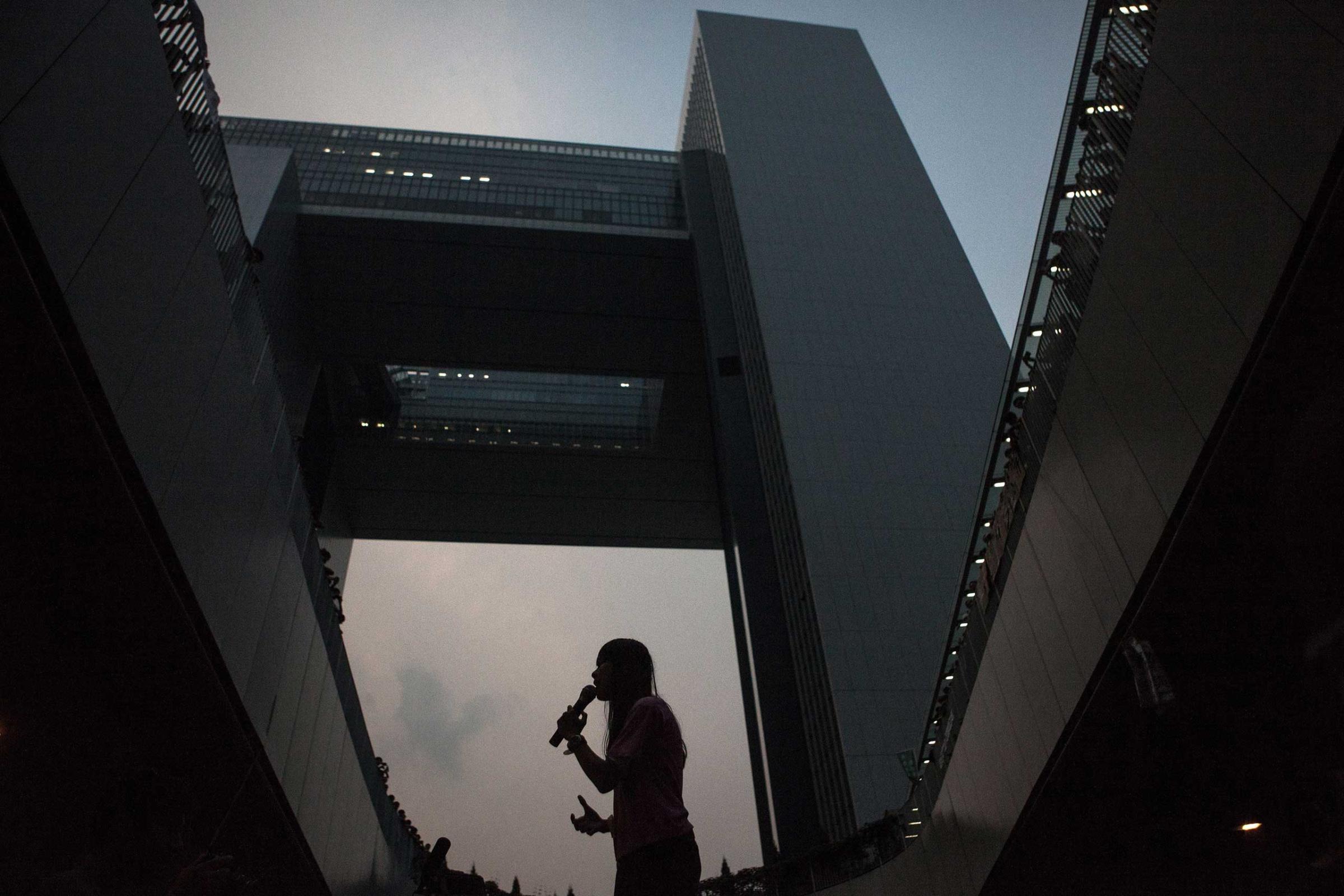 A pro-democracy protestor speaks to the crowd in front of the government offices in Hong Kong on Sept. 30, 2014.