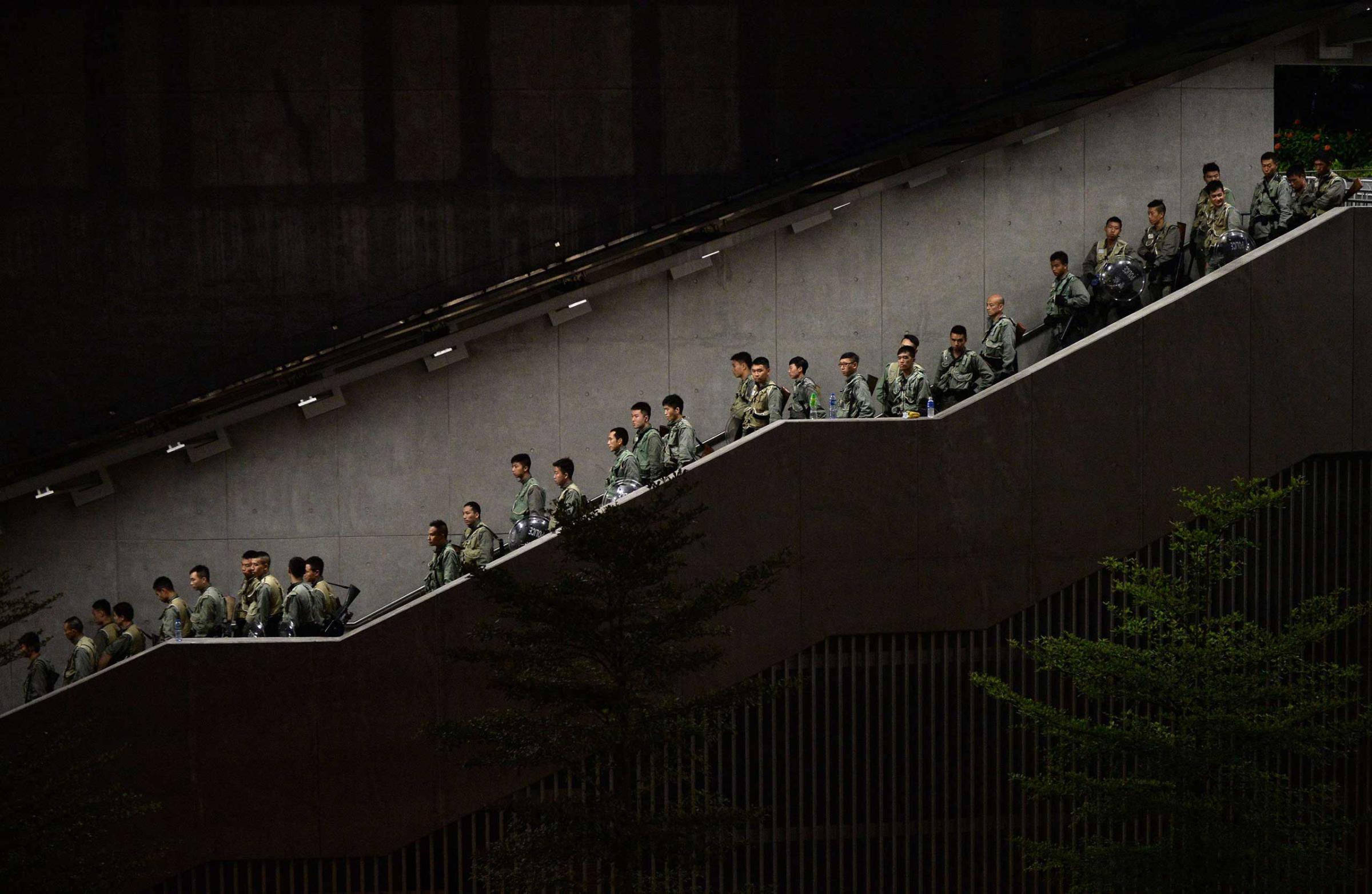 Police walk down a stairwell as pro-democracy demonstrators gather for a rally outside the Hong Kong government headquarters on Sept. 29, 2014.