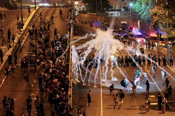 Riot police fire tear gas on student protesters occupying streets surrounding the government headquarters in Hong Kong, early on Sept. 29, 2014.