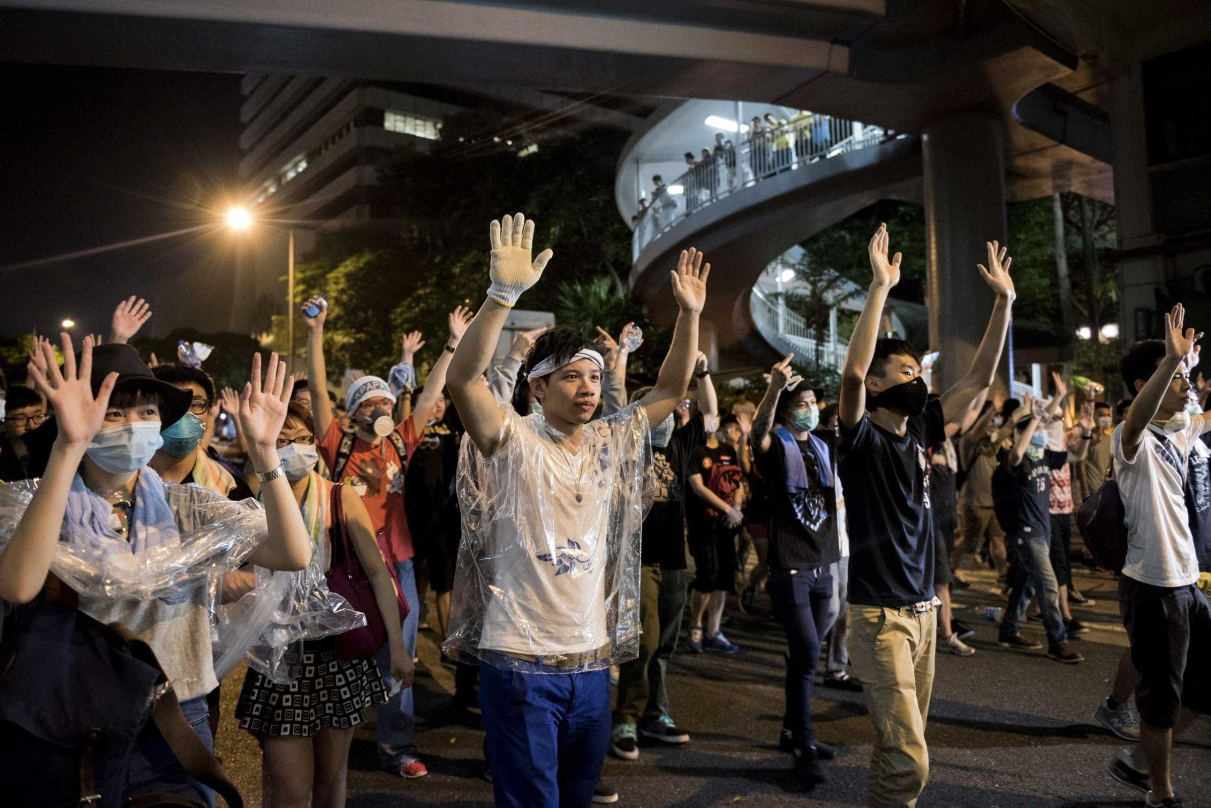 Pro-democracy protesters put their hands up in the air in front of the police in Hong Kong on Sept. 28, 2014.