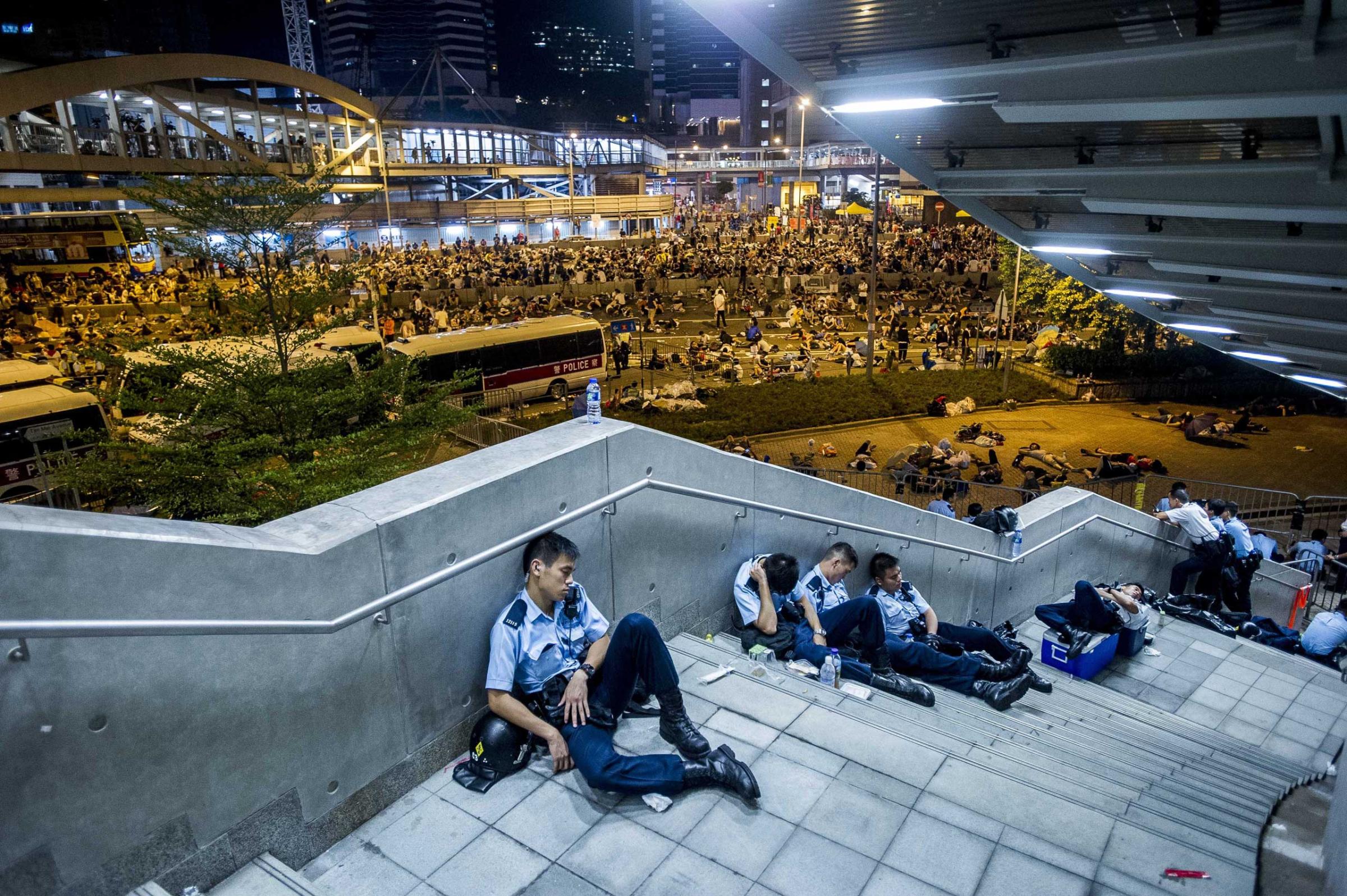 Policemen rest following pro-democracy protests in Hong Kong on Sept. 29, 2014.