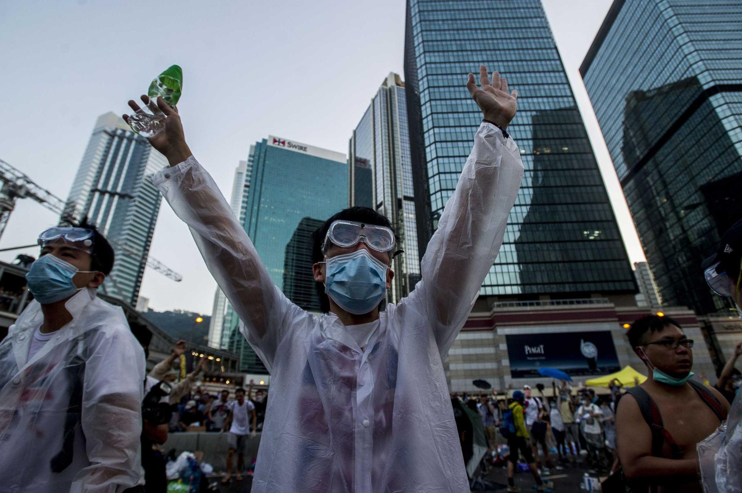 A pro-democracy demonstrator wearing a mask and goggles to protect against pepper spray and tear gas gestures during a rally near the Hong Kong government headquarters on Sept. 28, 2014.