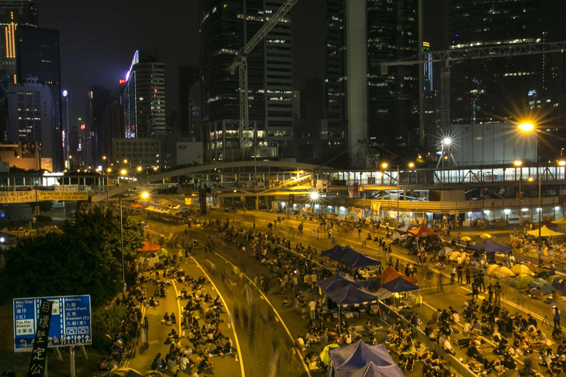 Protesters walk along the protest site on a quiet night as the standoff continues Oct. 5, 2014 in Hong Kong.