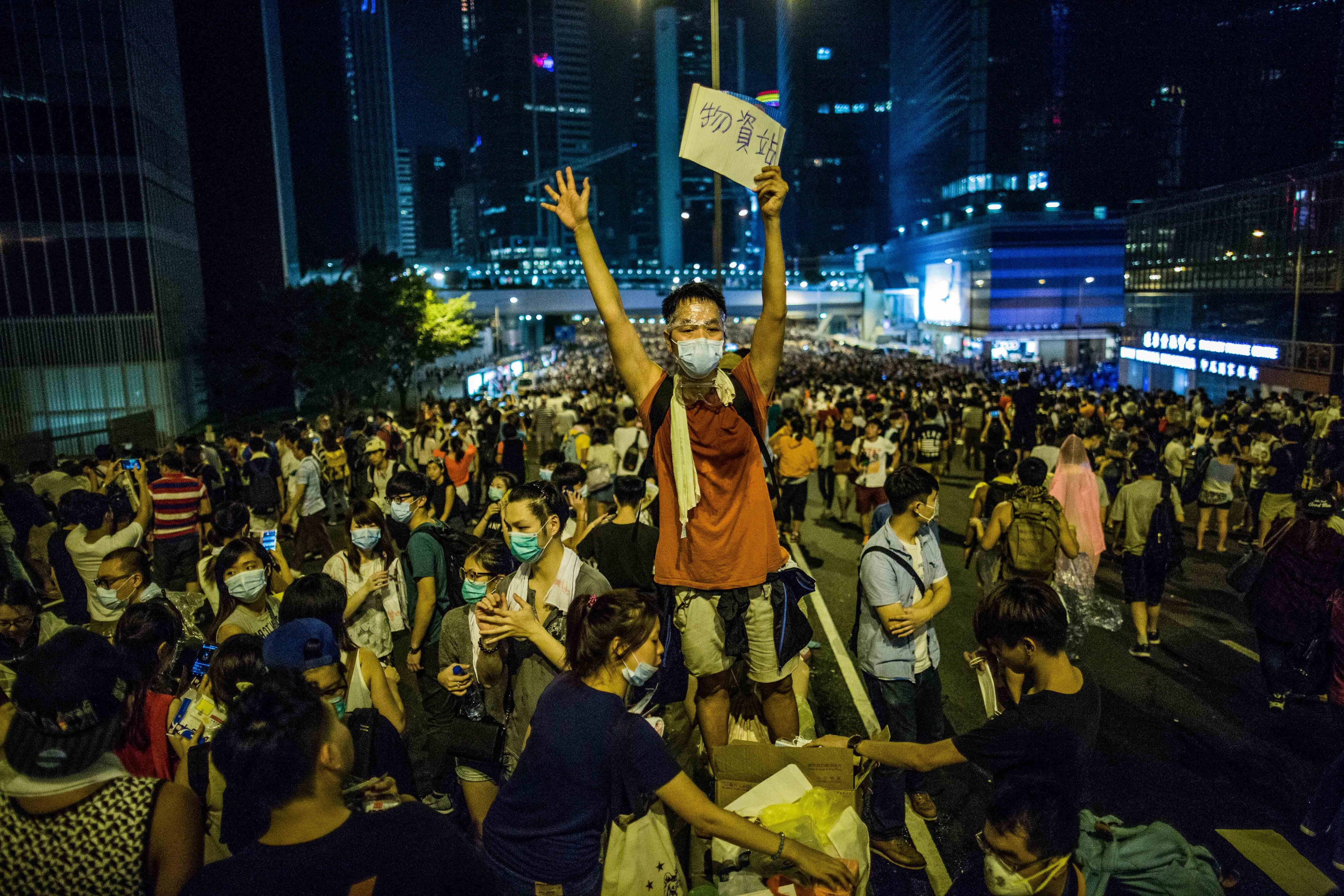 A man holds a sign that reads "Supplies" in Hong Kong on Sept. 28, 2014. The pro-democracy protesters occupy several city blocks surrounding the government headquarters, effectively blocking key roads linking Central to the rest of Hong Kong Island (Todd Darling—Polaris)