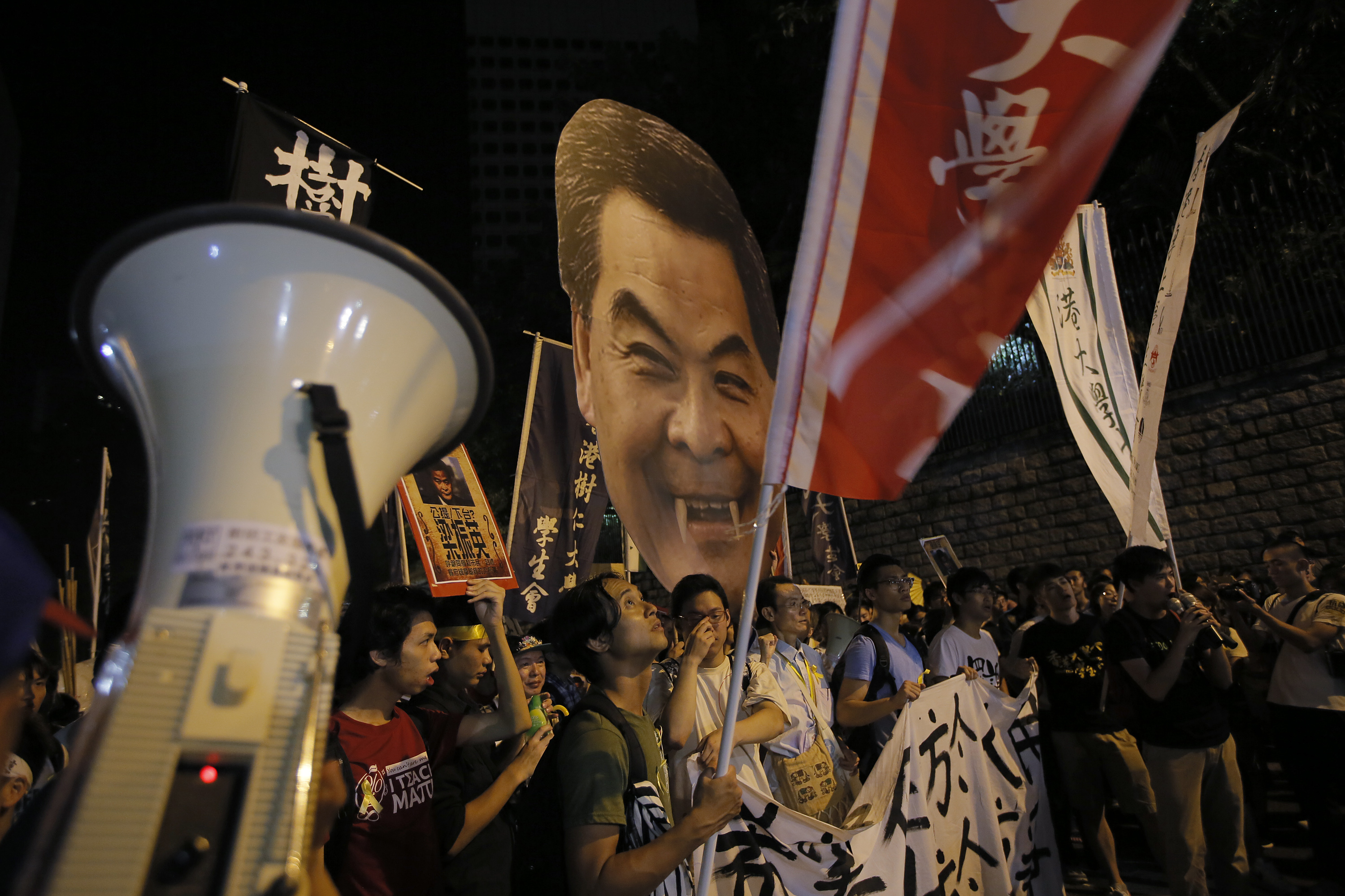 Students carry a defaced picture of Hong Kong Chief Executive Leung Chun-ying during a protest in Hong Kong on Sept. 25, 2014 (Vincent Yu&mdash;AP)