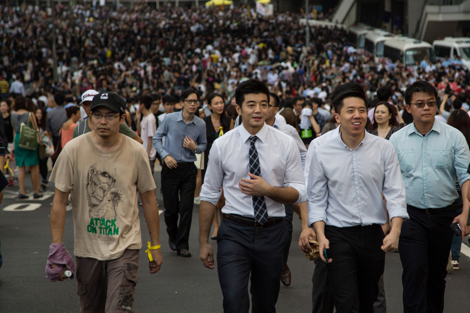 Office workers walk through closed off streets in front of protesters near the central government offices in the business district of Central in Hong Kong on Sept. 29, 2014 (Bloomberg—Getty Images)
