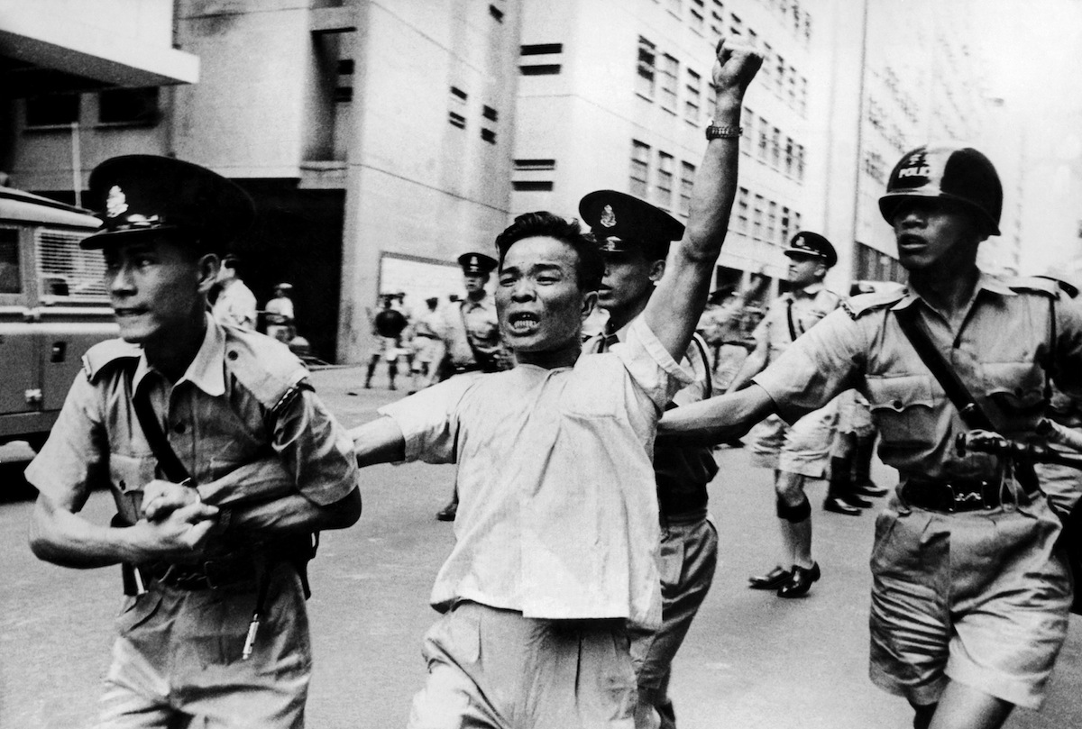 A pro-China protester arrested by police officers during a demonstration in Hong Kong on May 18, 1967. (Gamma-Keystone / Getty Images)