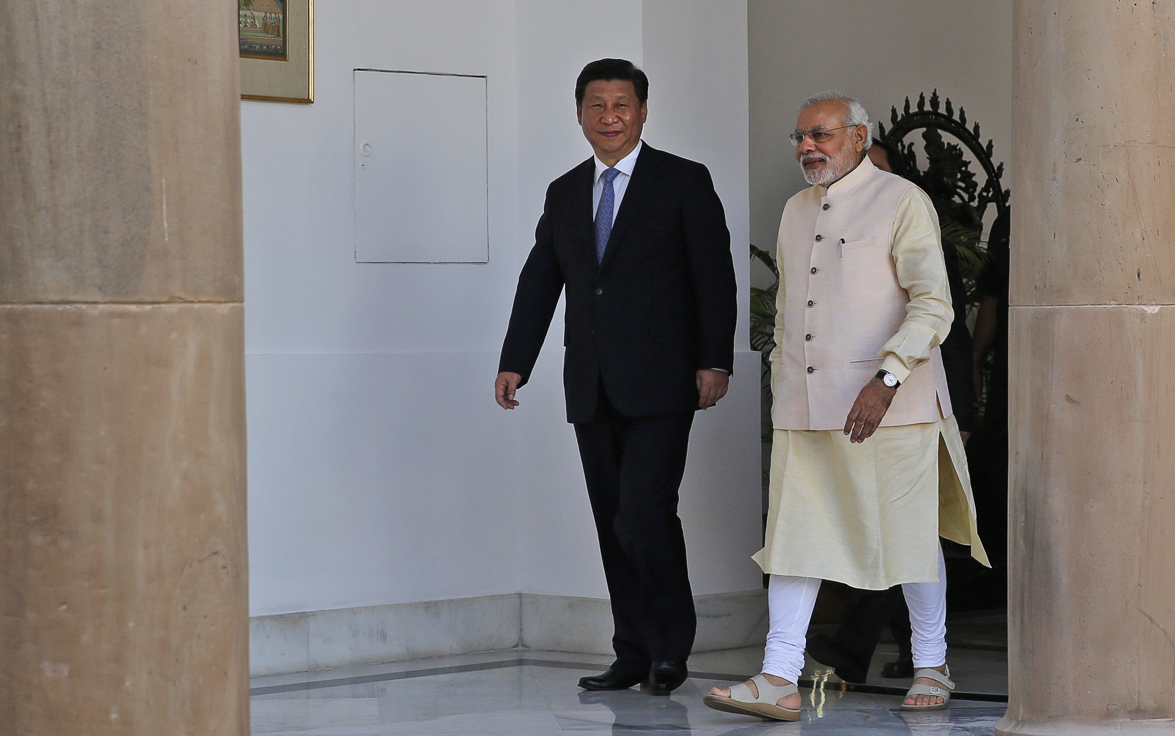 Indian Prime Minister Narendra Modi and visiting Chinese President Xi Jinping walk for a meeting in New Delhi, India, Thursday, Sept. 18, 2014. (Manish Swarup—AP)