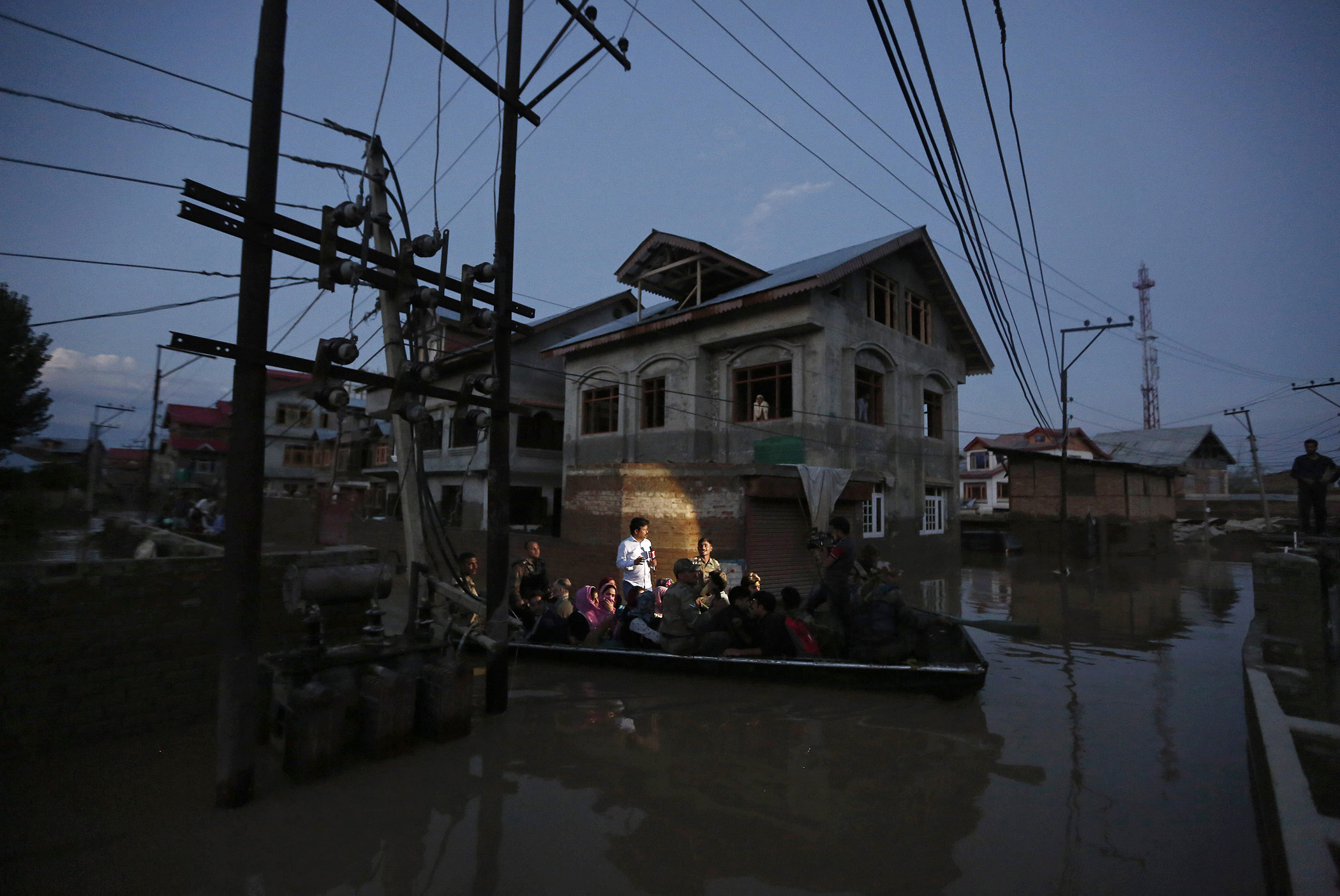 Flood victims are evacuated by boat from their flooded house in Srinagar, Sept. 10, 2014.
