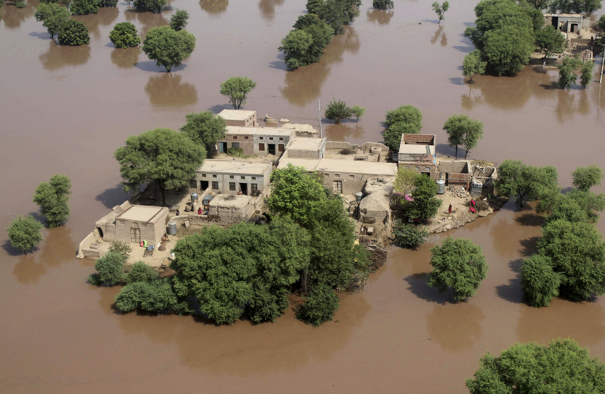 An aerial view shows houses surrounded by flood waters in district Multan, Pakistan, Sept. 12, 2014.