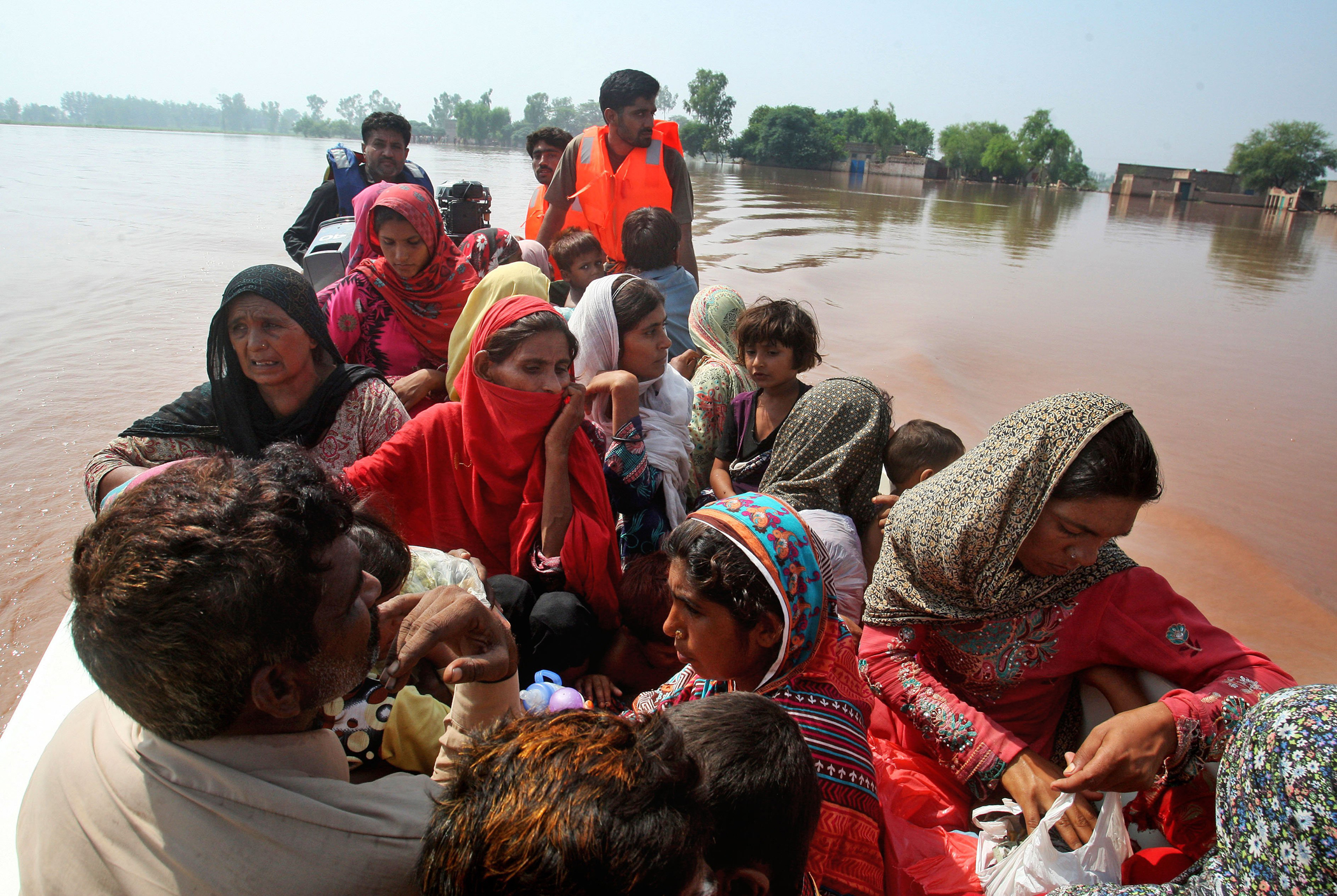Pakistani volunteers rescue villagers in Chiniot, 100 miles northwest of Lahore, Pakistan, Sept. 9, 2014.