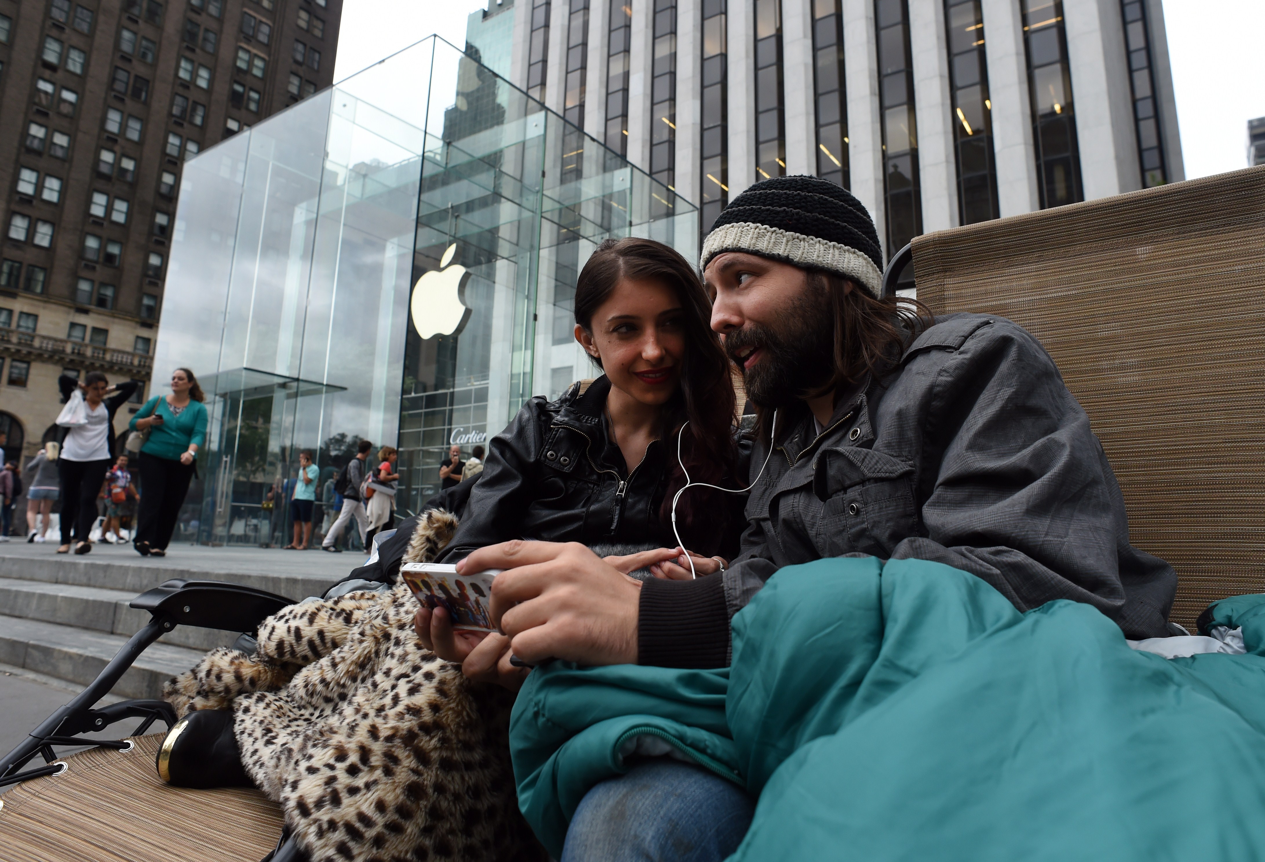 Moon Ray (L) and her husband Jason Ray talk on Skype as they wait in line September 9, 2014 outside the Apple Store on 5th Avenue in New York. (Don Emmert&mdash;AFP/Getty Images)