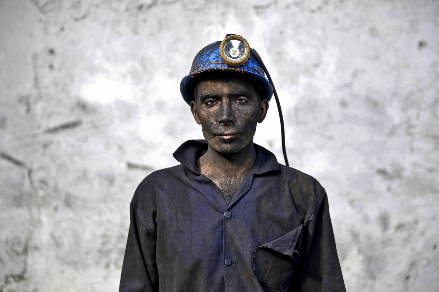 An Iranian coal miner with his face smeared black from coal poses for a photograph at a mine near the city of Zirab, 132 miles northeast of the capital Tehran, on a mountain in Mazandaran province, Iran. May 7, 2014.