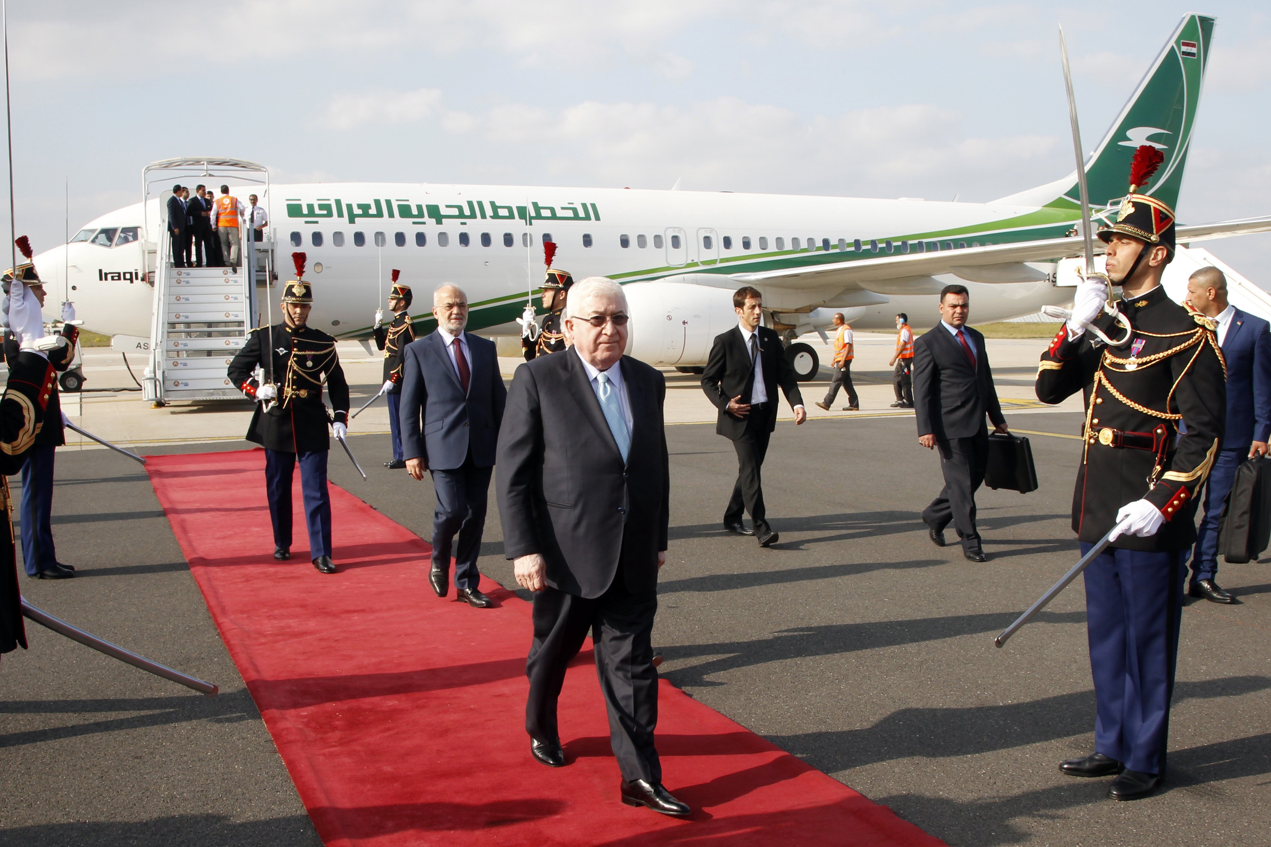 Iraq President Fouad Massoum, center, followed by Iraq Foreign Minister Ibrahim Al-Jaafari, left, arrive with Iraqi officials at Orly airport south of Paris, on Sept. 14, 2014 . (Francois Mori—AP)