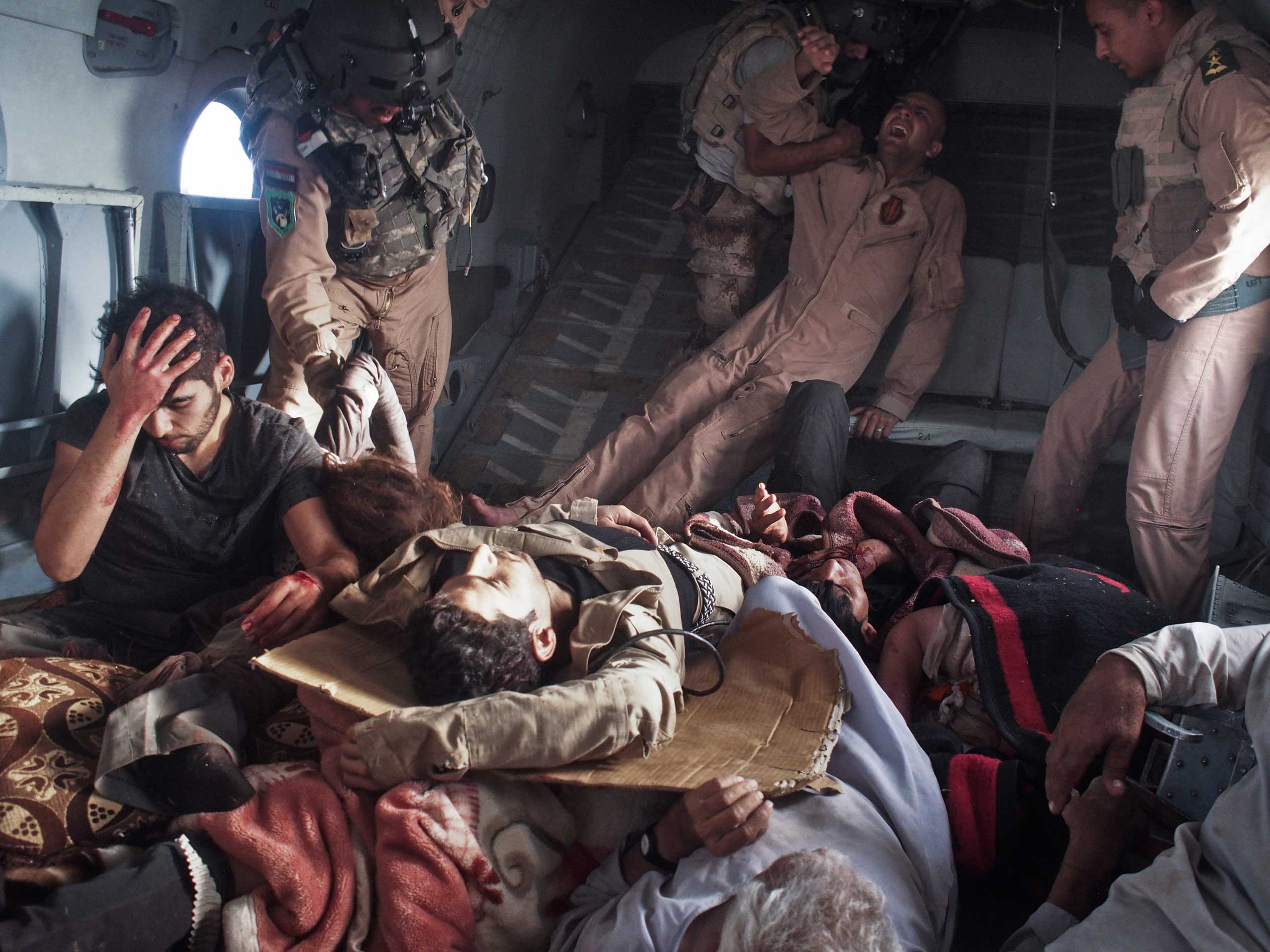 Survivors of the crash, including Yazidi refugees and Kurdish and Iraqi Army personnel, onboard a rescue helicopter that transported them from the crash site back to Kurdish-controlled Dohuk Province. Sinjar Mountains, Iraq, Aug. 12, 2014.