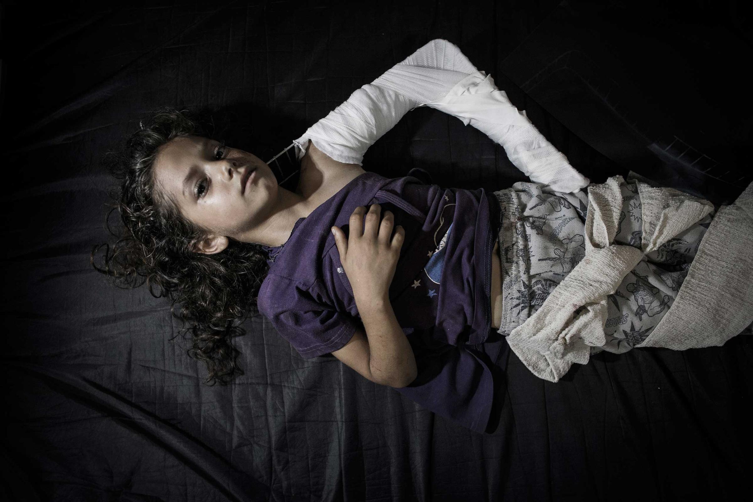 A young Palestinian girl, who was injured when a U.N. school was caught in the crossfire—Israel and Hamas blamed one another—lies on a hospital bed in the emergency room of Kamal Adwan hospital in Beit Lahiya, Gaza Strip, July 24, 2014.