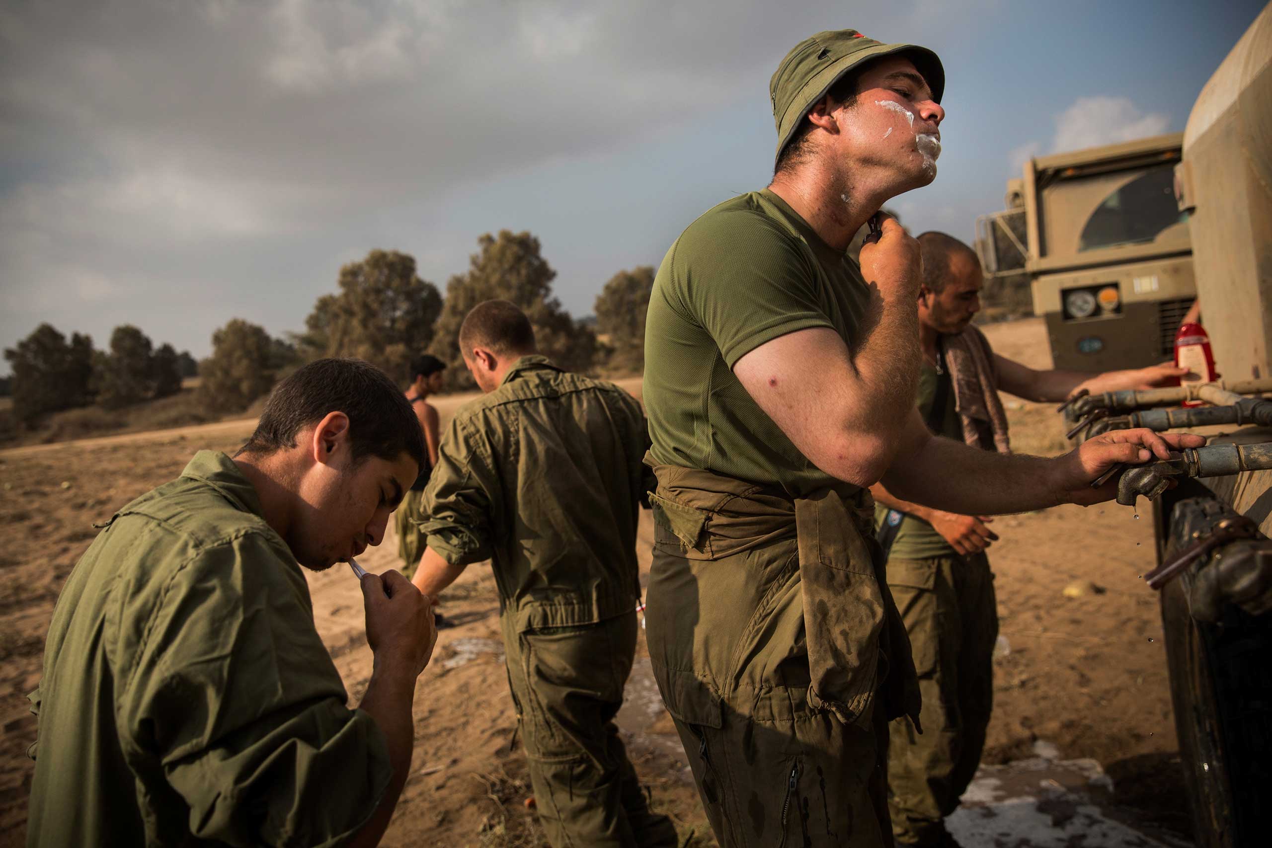 An Israeli soldier shaves near Kafar Azza, Israel on the morning of July 28, 2014.