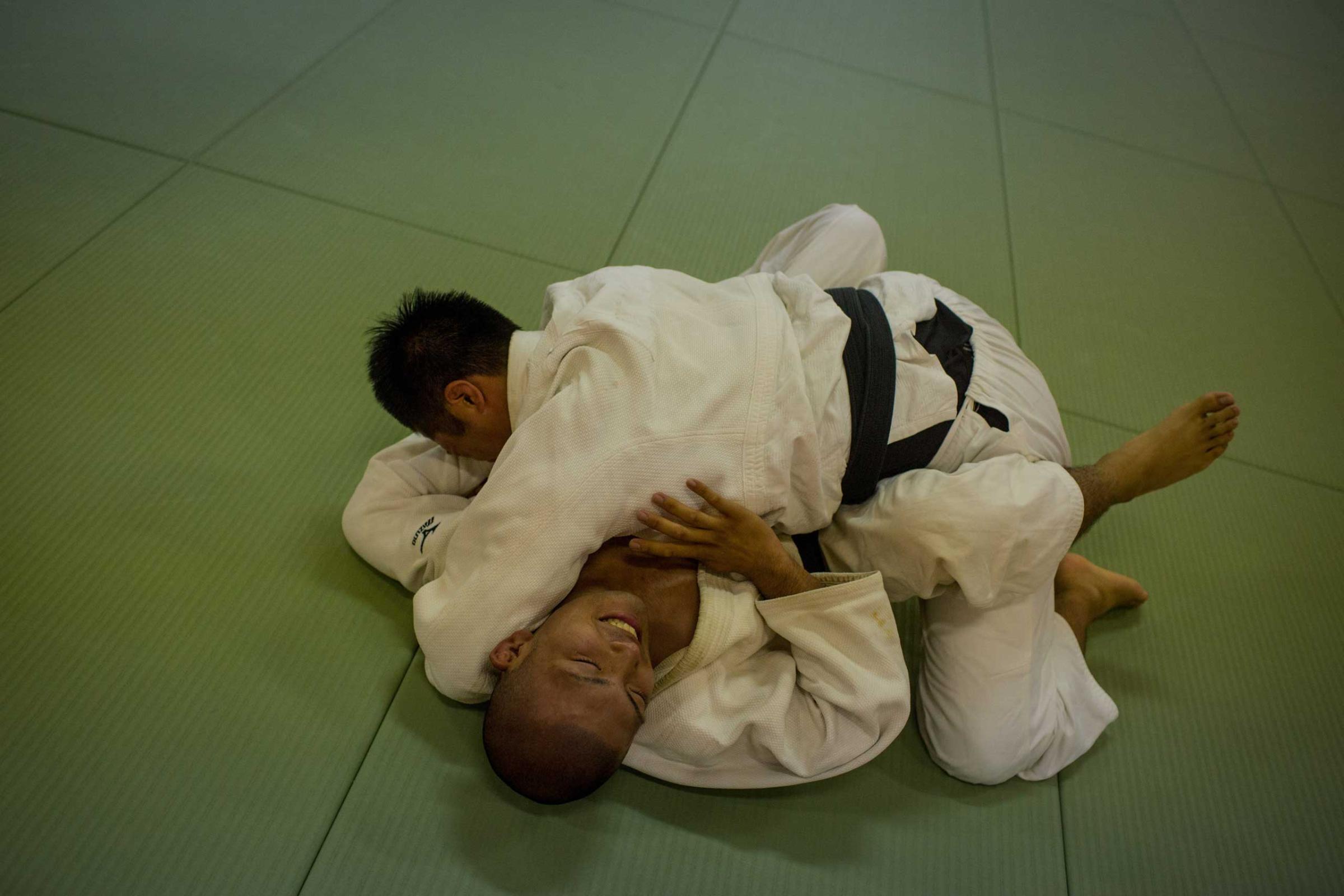 A student grapples with his teacher during Judo classes.