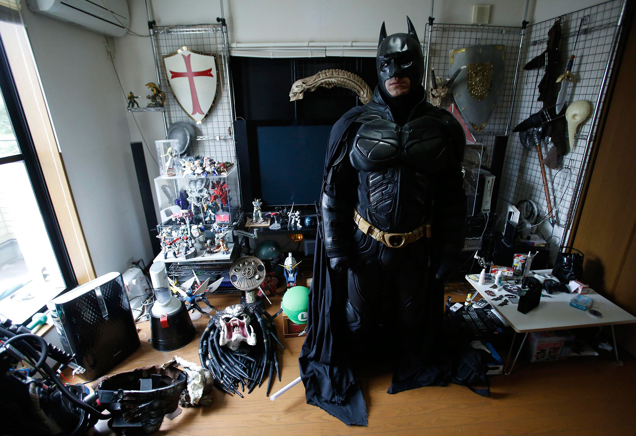 A 41-year-old man going by the name of Chibatman poses in his room before going on the road on his "Chibatpod" in Chiba, east of Tokyo