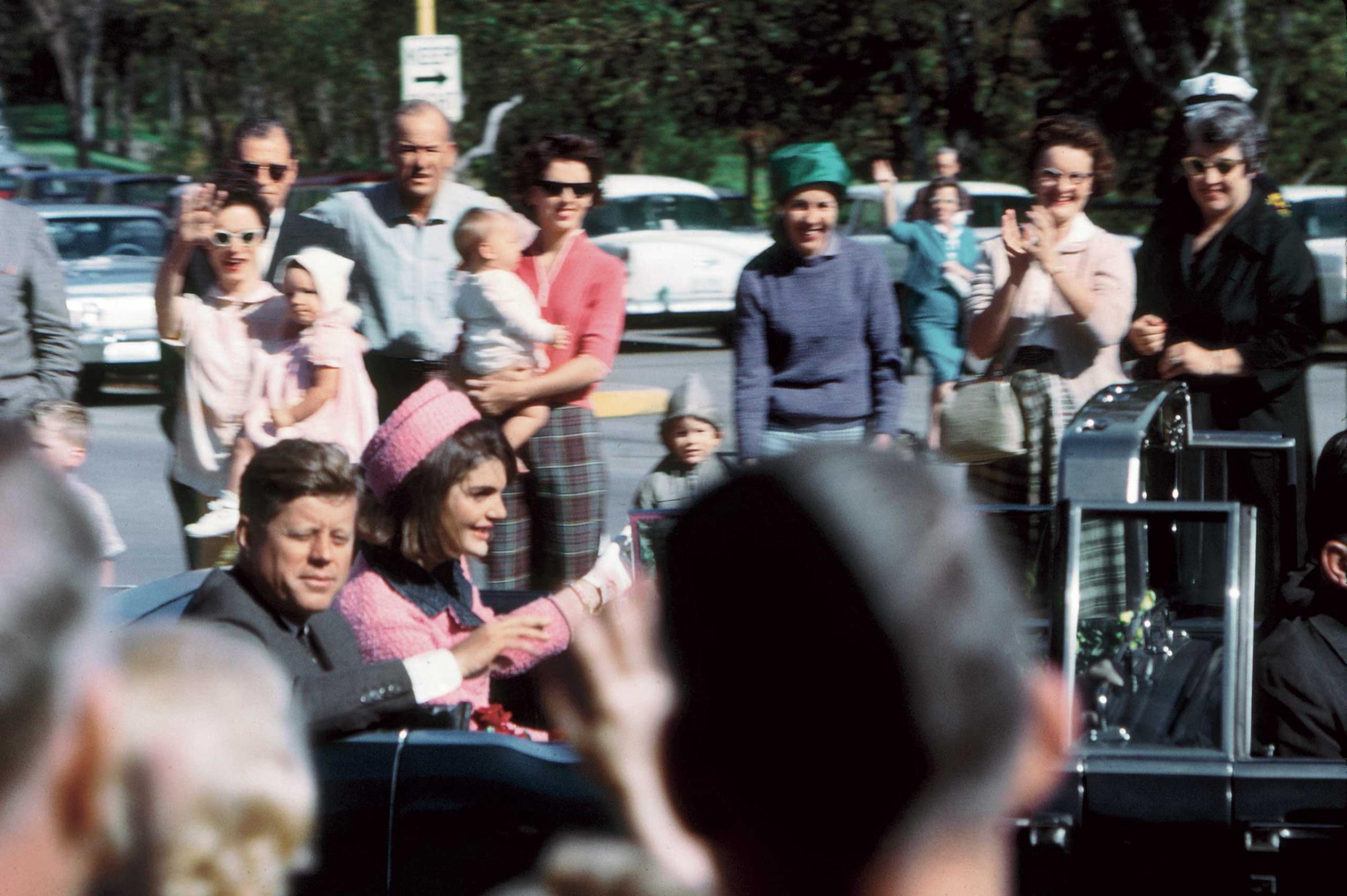 Kennedy's well-wishers crowded close to his limousine as the motorcade neared Dealey Plaza.