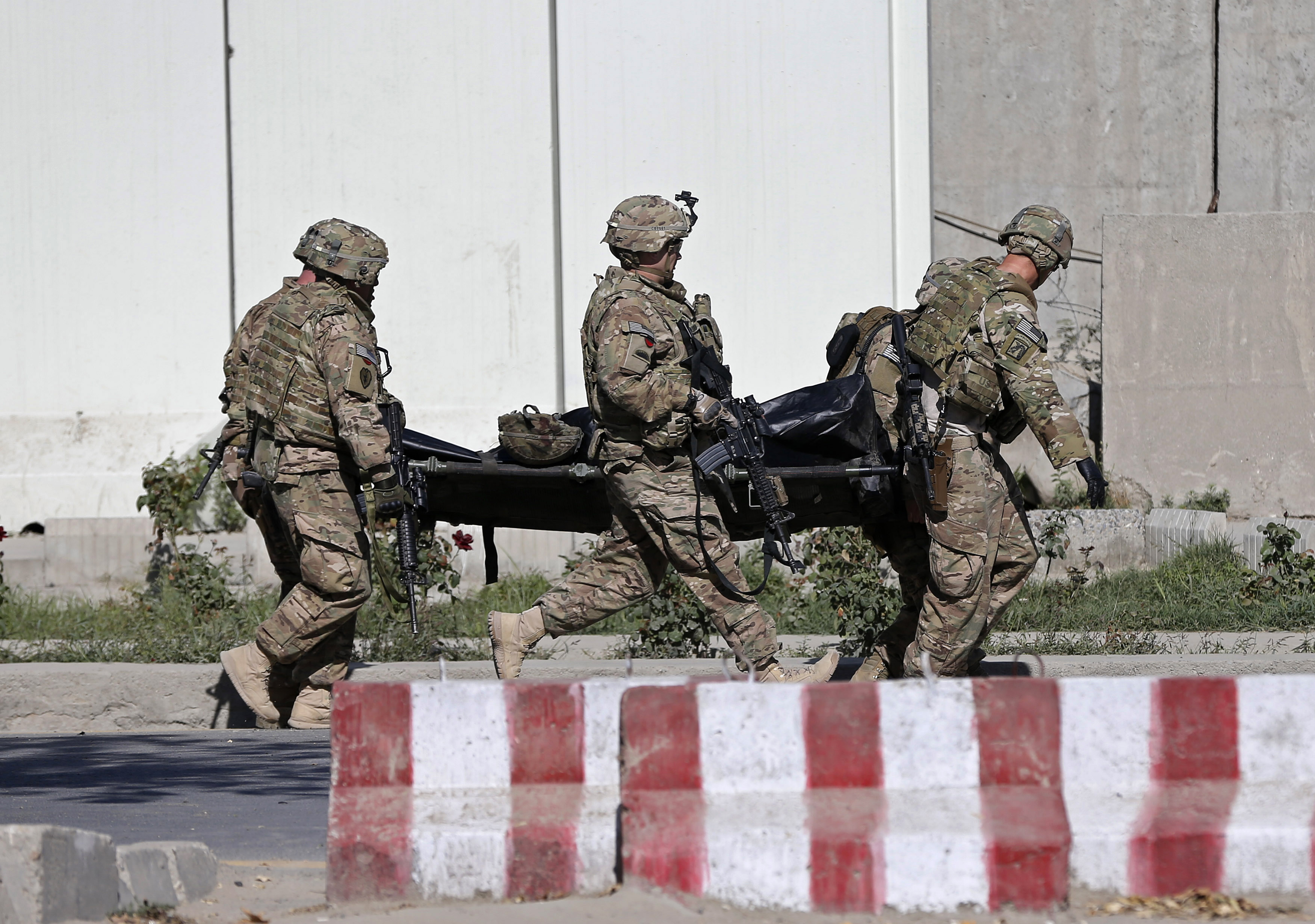U.S. troops carry the dead body of a member of an international troop at the site of suicide attack in Kabul September 16, 2014. (Omar Sobhani — Reuters)